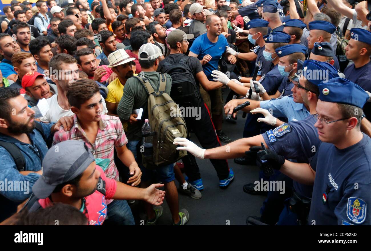 Migrants face Hungarian police in the main Eastern Railway station in Budapest, Hungary, September 1, 2015. Hungary closed Budapest's main Eastern Railway station on Tuesday morning with no trains departing or arriving until further notice, a spokesman for state railway company MAV said. There are hundreds of migrants waiting at the station. People have been told to leave the station and police have lined up at the main entrance, national news agency MTI reported. REUTERS/Laszlo Balogh   TPX IMAGES OF THE DAY Stock Photo