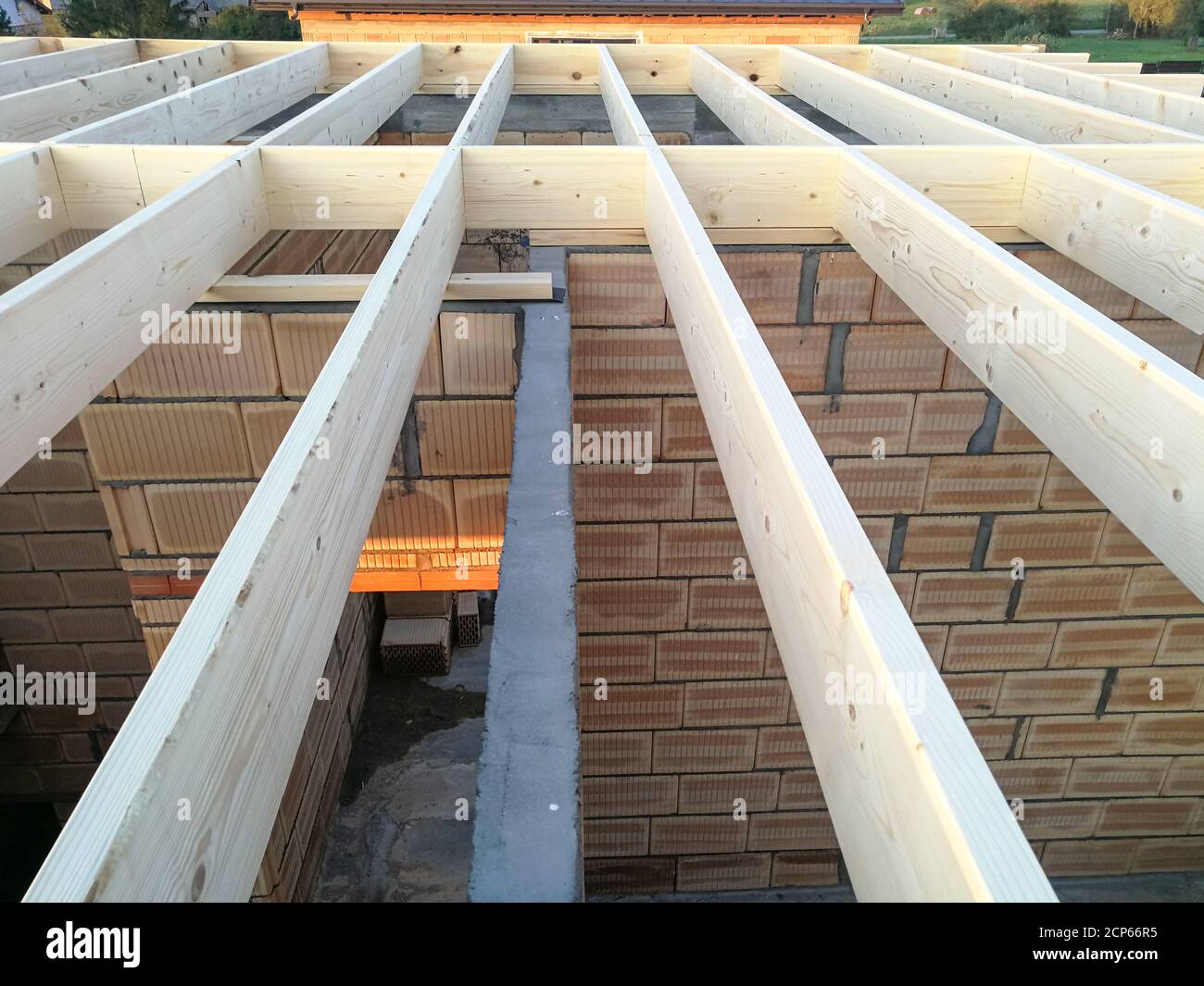Wood girder beams for new roof construction at construction site Stock Photo
