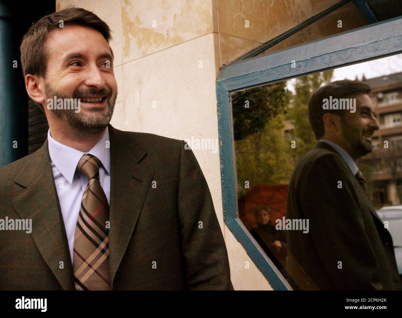 Josu Jon Imaz, spokesman for the Basque regional government and new elected president of ruling nationalist party, the Partido Nacionalista Vasco (PNV) is reflected in a mirror as he arrives for a news conference in Vitoria December 19, 2003. Imaz was elected by PNV's militants as new party leader later December 18, replacing current leader Xavier Arzallus. REUTERS/Vincent West  SP/GB Stock Photo