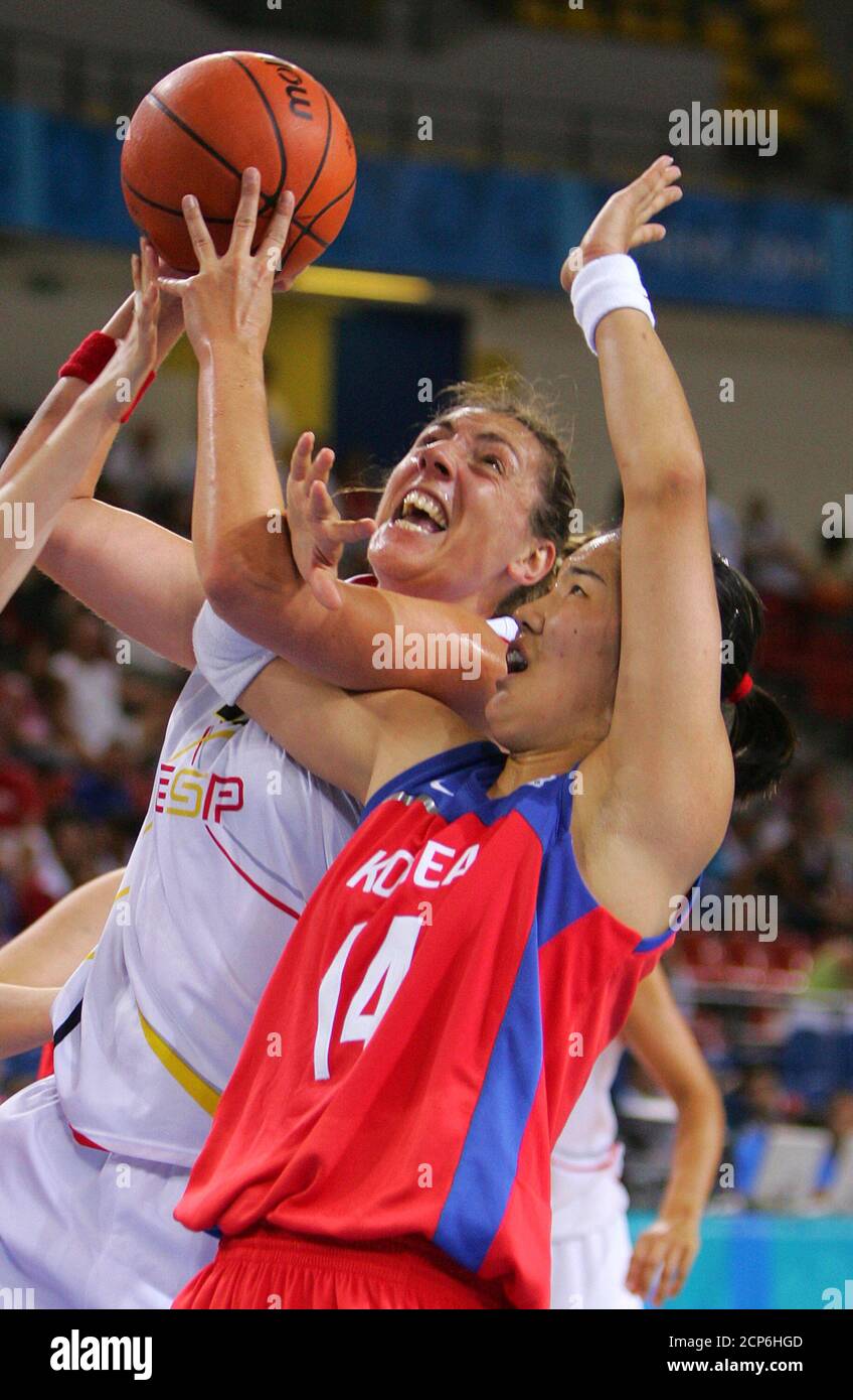 Ferragut of Spain shoots over the hands of Kim Kwe Ryong of South Korea during Olympic basketball game in Athens.  Spain's Marina Ferragut (L) shoots over the hands of South Korea's Kim Kwe Ryong during their women's preliminary basketball game at the Athens 2004 Olympic Games, August 22, 2004. REUTERS/Adrees Latif Stock Photo