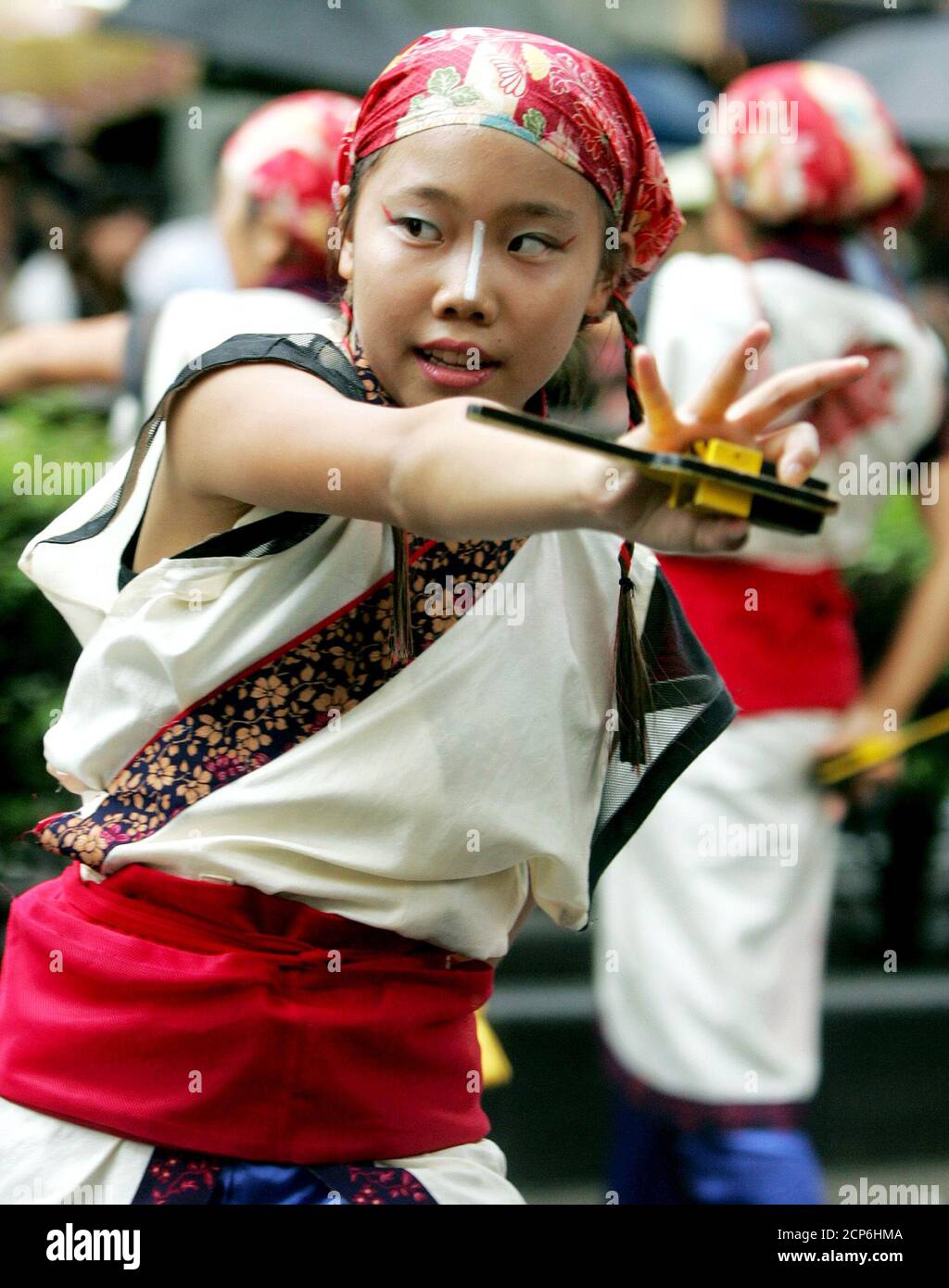 A Japanese girl dances with 'naruko' or clappers in her hands during Yosakoi festival in Tokyo August 29, 2004. About 6,000 dancers in colourful costumes from all over Japan took part in the festival, according to the organisers. REUTERS/Yuriko Nakao  YN/LA Stock Photo