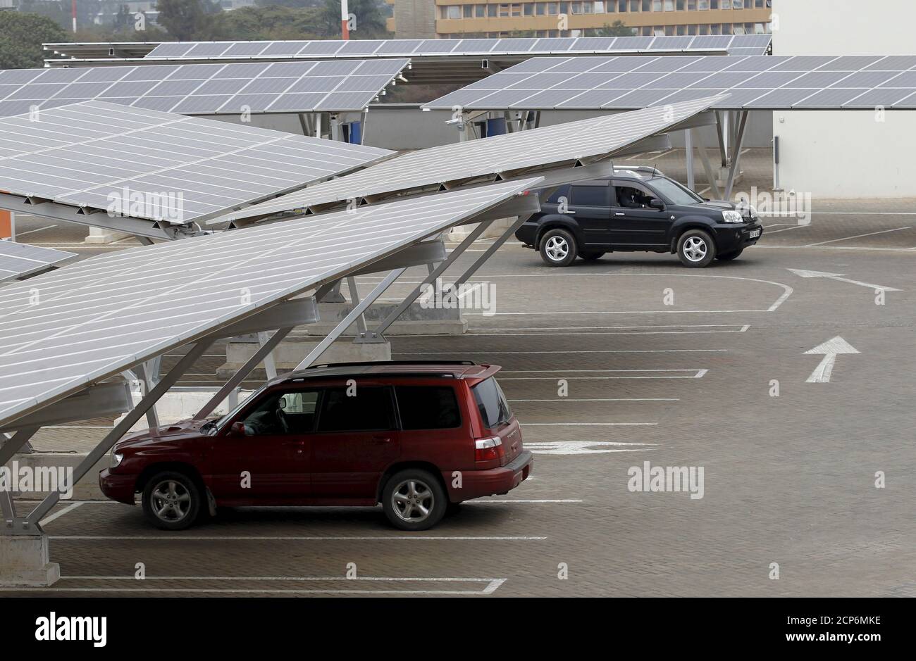 A car is seen parked under solar panels at a solar carport at the Garden City shopping mall in Kenya's capital Nairobi, September 15, 2015. The Africa's largest solar carport with 3,300 solar panels will generate 1256 MWh annually and cut carbon emission by around 745 tonnes per year, according to Solarcentury and Solar Africa.  REUTERS/Thomas Mukoya Stock Photo