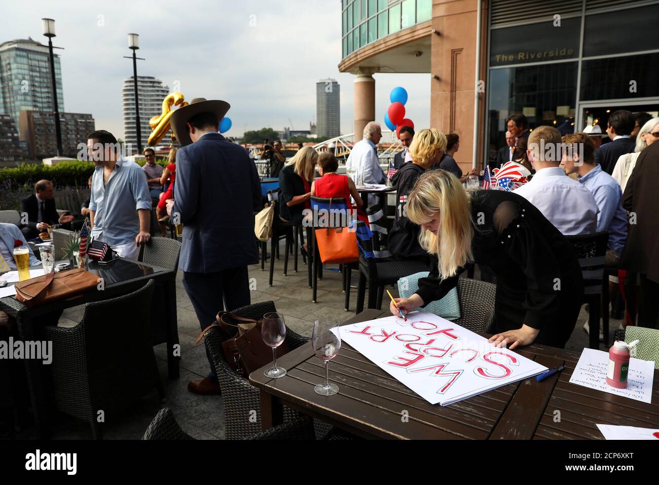 An attendee writes a placard ahead the visit to the United Kingdom of Donald Trump the President of the United States at a Republicans Overseas event in London, Britain, July 4, 2018. Picture taken July 4, 2018. REUTERS/Simon Dawson Stock Photo