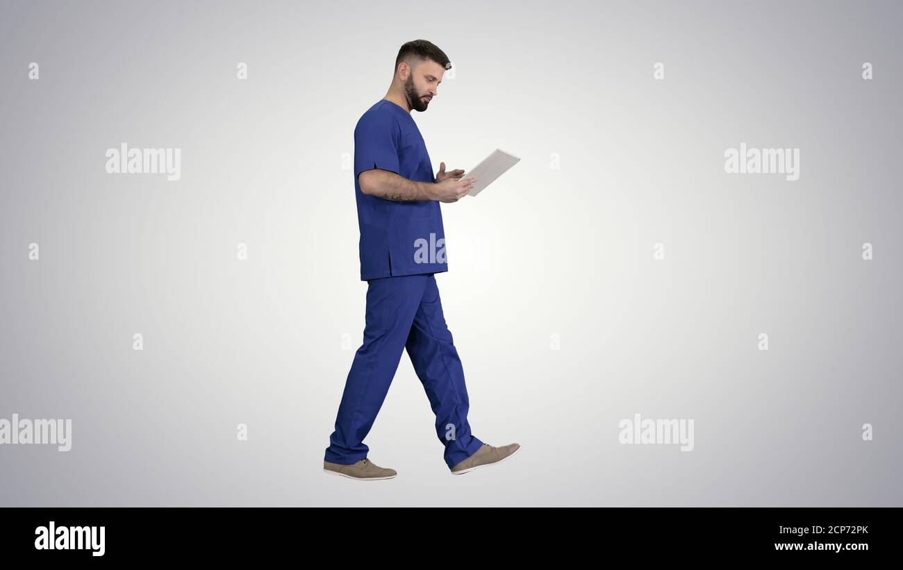 Confident concentrated focused surgeon using digital tablet on g Stock Photo