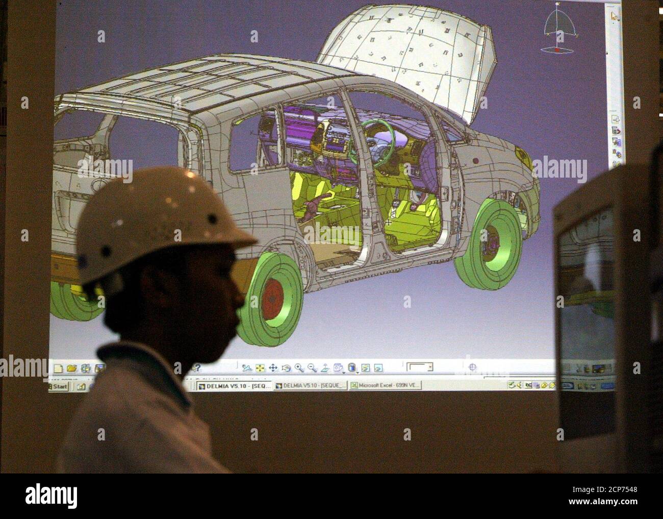 An Indonesian worker reviews a schematic design of a new multi-purpose vehicle, called Kijang Innova, at the Toyota plant in Karawang, West Java province on September 1, 2004. Indonesia's leading auto distributor, PT Astra International Tbk, launched a new generation of its best selling car on Wednesday. REUTERS/Beawiharta  REUTERS/Beawiharta Stock Photo