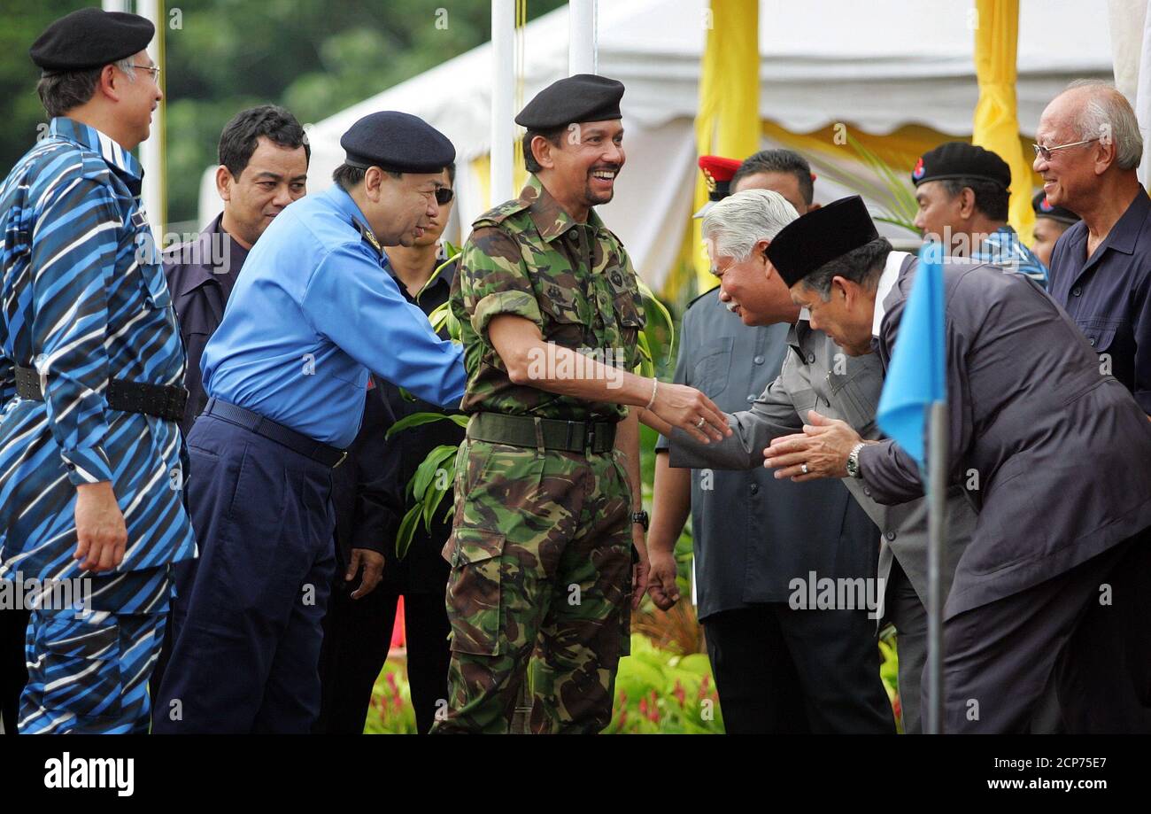Visiting Sultan of Brunei Hassanal Bolkiah (C) is greeted during his visit to a training camp in Semenyih, outside Kuala Lumpur April 29, 2005. The Sultan arrived in the Malaysia's capital of Kuala Lumpur on Wednesday for a four-day state visit on the invitation of Malaysia's King. REUTERS/Bazuki Muhammad  BM/MK Stock Photo