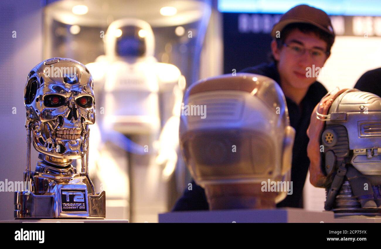 A visitor stands in front of science-fiction film replica heads at the  exhibition 'Robots - From Motion to Emotion ?' at the Museum fuer  Gestaltung (museum of design) in Zurich June 30,