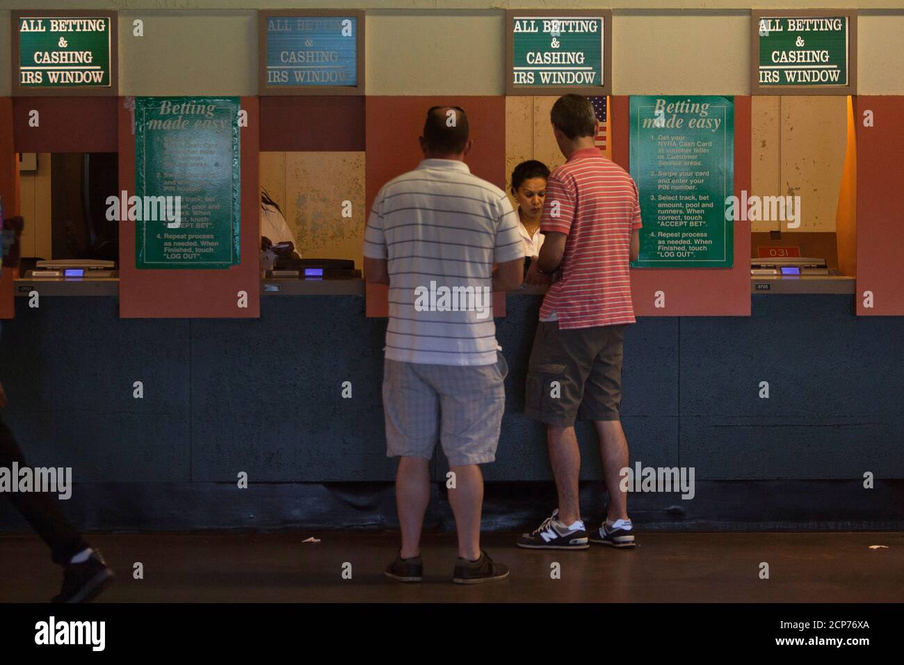 People place bets before the 2014 Belmont Stakes in Elmont, New York June 7, 2014. REUTERS/Carlo Allegri (UNITED STATES - Tags: SPORT HORSE RACING SOCIETY) Stock Photo
