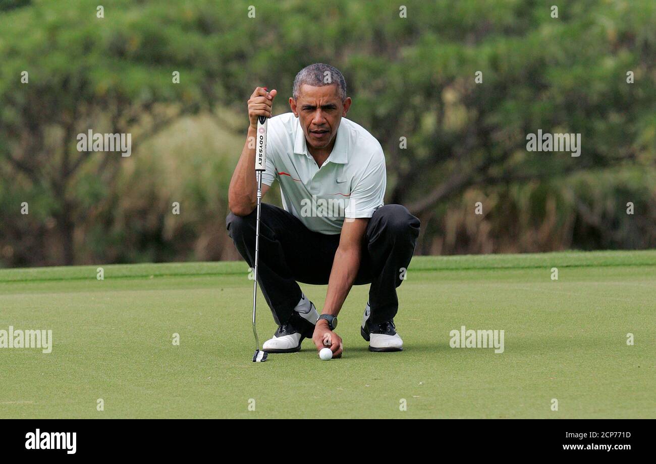 U.S. President Barack Obama lines up his ball as he and Malaysia's Prime Minister Najib Razak play on the 18th green at the Clipper Golf course on Marine Corps Base Hawaii during Obama's Christmas holiday vacation in Kaneohe, Hawaii, December 24, 2014. REUTERS/Hugh Gentry (UNITED STATES - Tags: POLITICS SOCIETY) Stock Photo