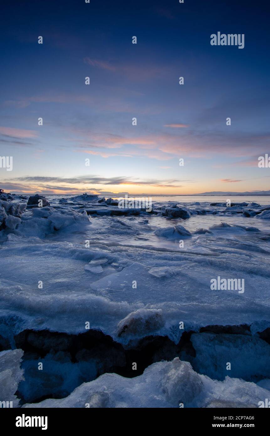 Sunset in Iceland, pastel color and cracks in Ice Stock Photo - Alamy