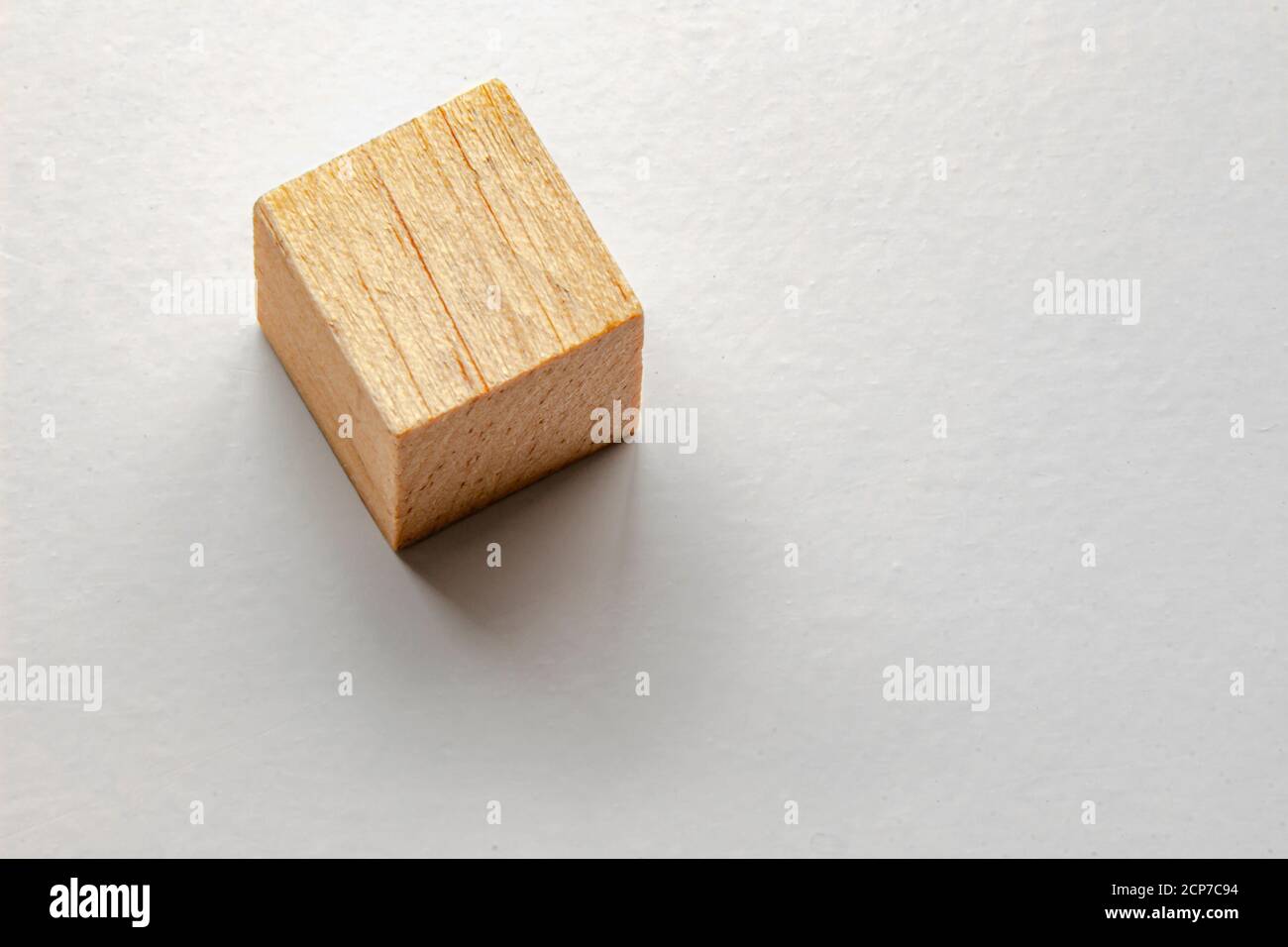 Wood cube with a soft shadow on grey table Stock Photo