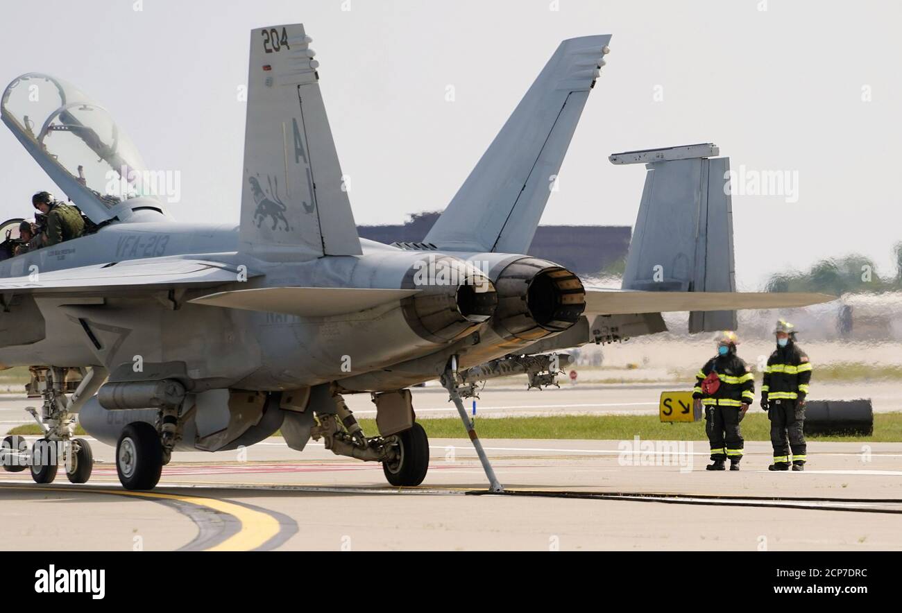 St. Louis, United States. 18th Sep, 2020. Firefighters stand near as a F-18 military jet powers down after making an emergency landing at St. Louis-Lambert International Airport in St. Louis on Friday, September 18, 2020. Photo by Bill Greenblatt/UPI Credit: UPI/Alamy Live News Stock Photo