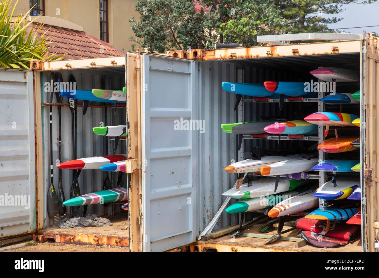 Ocean sea kayaks stored in shipping containers at Newport Beach in