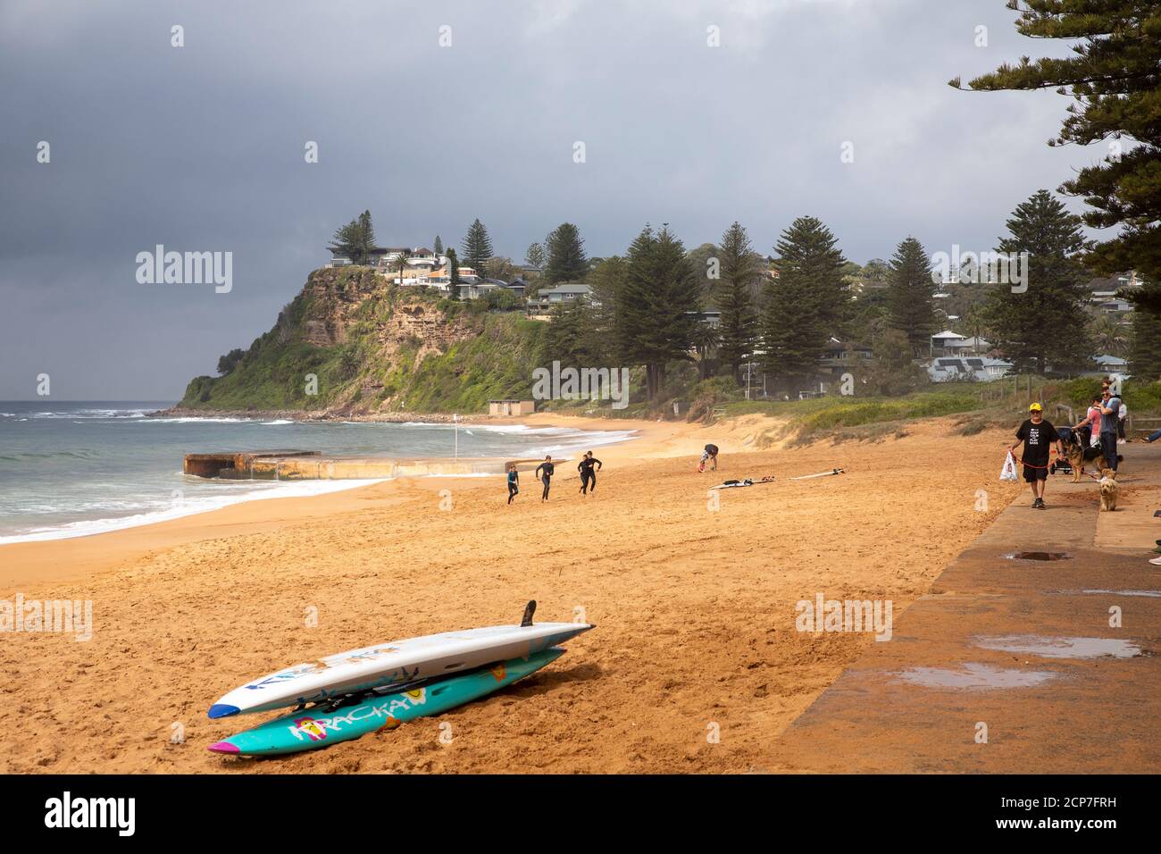 Newport beach in Sydney and surfboards on the sand, dark skies above as storm weather encroaches,Sydney,Australia Stock Photo