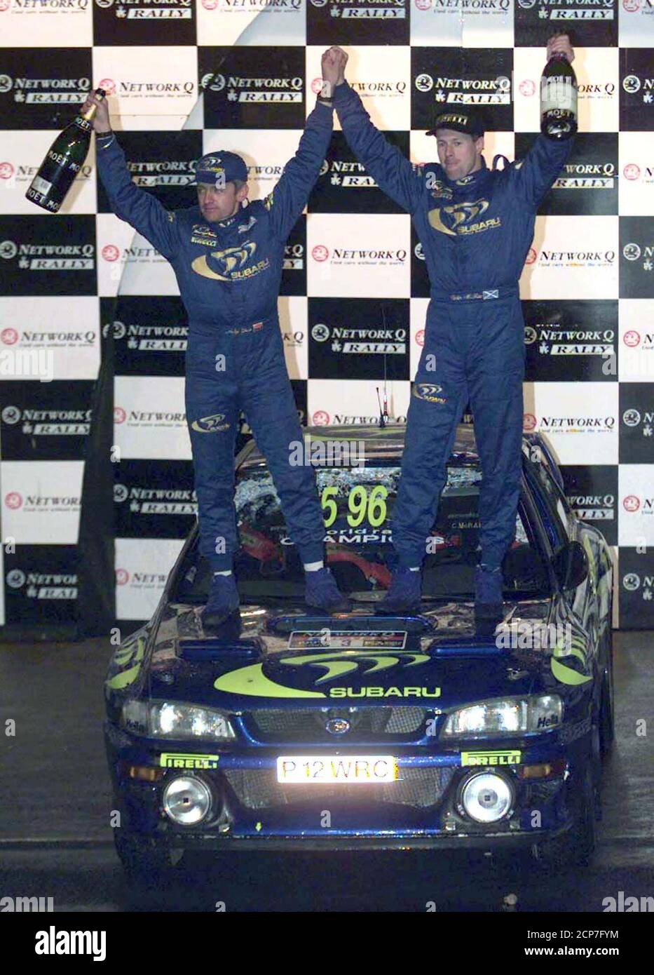 Scotland's Colin McRae celebrates atop his Subaru Impreza with navigator Nicky  Grist (L) after winning the British RAC Rally November 25. McRae was beaten  into second place of the World Rally Championships