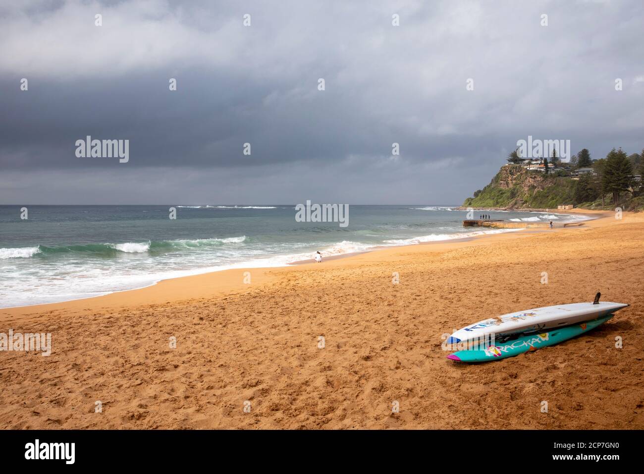 Newport beach in Sydney and surfboards on the sand, dark skies above as storm weather encroaches,Sydney,Australia Stock Photo