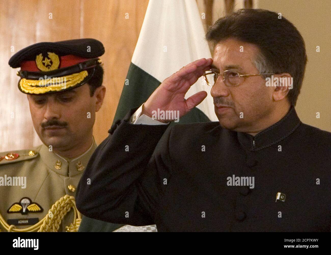 Pakistan's President Pervez Musharraf (R) salutes before being sworn in at the President House in Islamabad November 29, 2007. Musharraf was sworn in for a second term on Thursday, but this as a civilian leader a day after quitting as army chief and fulfilling a promise many Pakistanis doubted he would keep.  REUTERS/Adrees Latif    (PAKISTAN) Stock Photo
