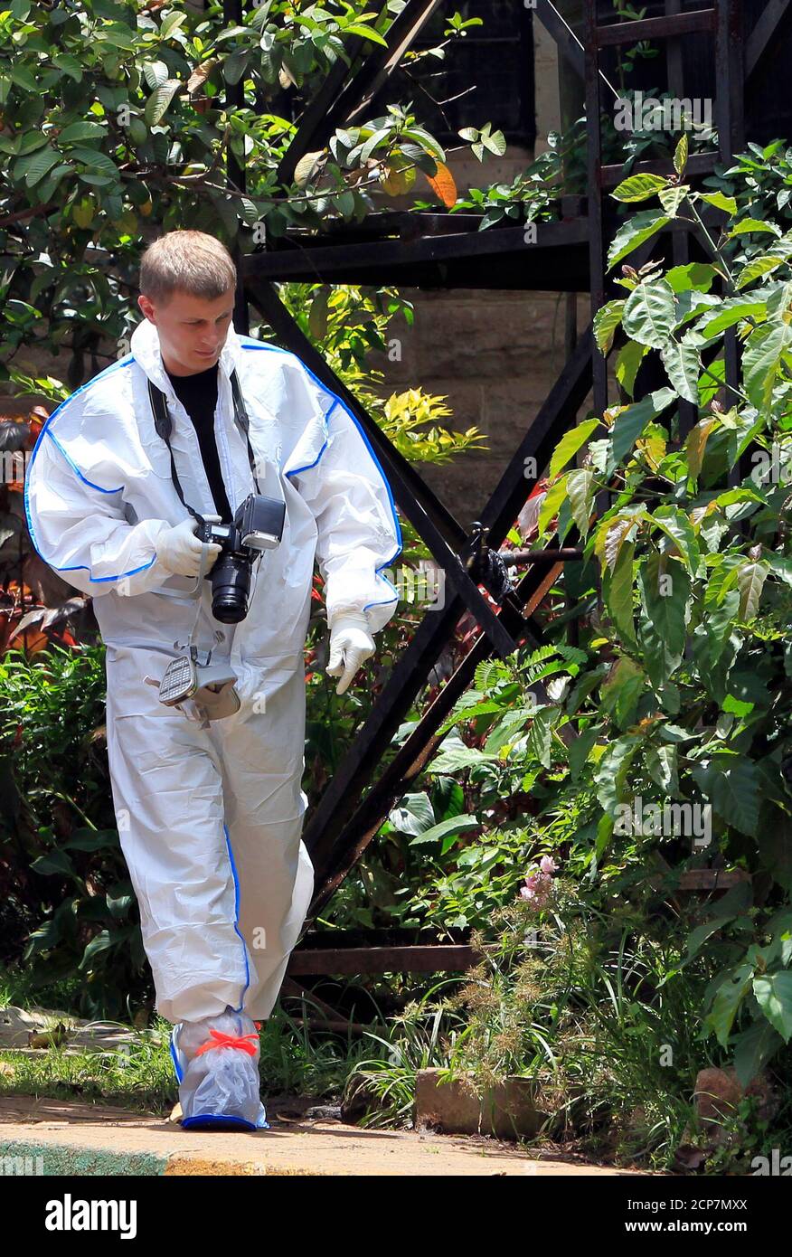A foreign forensic expert arrives to collect data on three dead victims of the attack on Westgate shopping mall last week, at the Nairobi City Mortuary September 26, 2013. U.S., British, Canadian and Israeli agencies are helping Kenya investigate the attack claimed by Somali Islamist militants on the Nairobi shopping mall that killed at least 72 people and destroyed part of the complex, officials said on Wednesday.          REUTERS/Noor Khamis (KENYA - Tags: CRIME LAW CIVIL UNREST DISASTER) Stock Photo