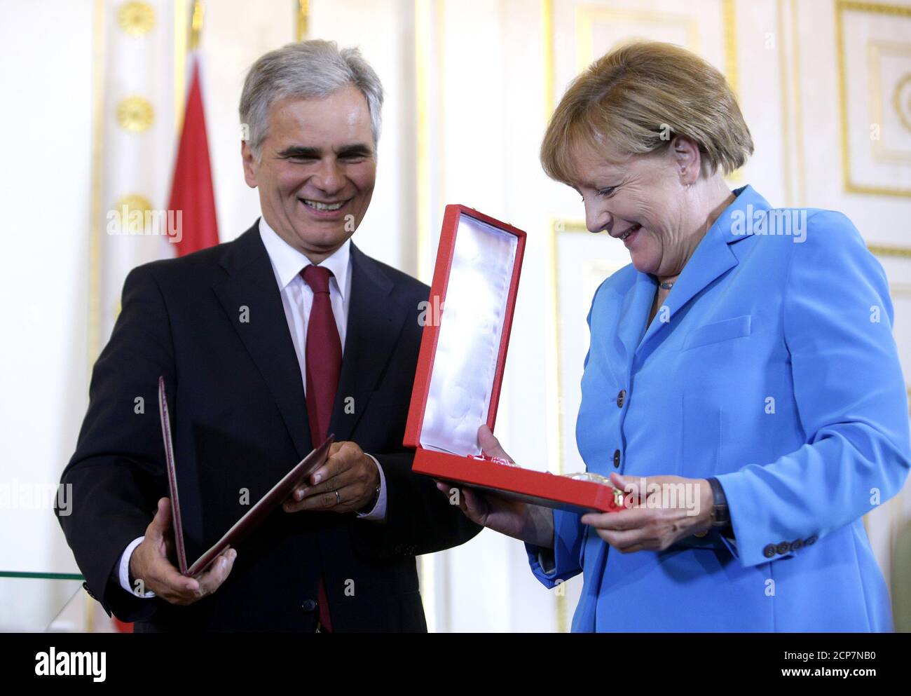 German Chancellor Angela Merkel receives the Golden Decoration of Honour for Services to the Republic of Austria from Austrian Chancellor Werner Faymann during the Western Balkans Summit in Vienna August 27, 2015.   REUTERS/Lisi Niesner Stock Photo