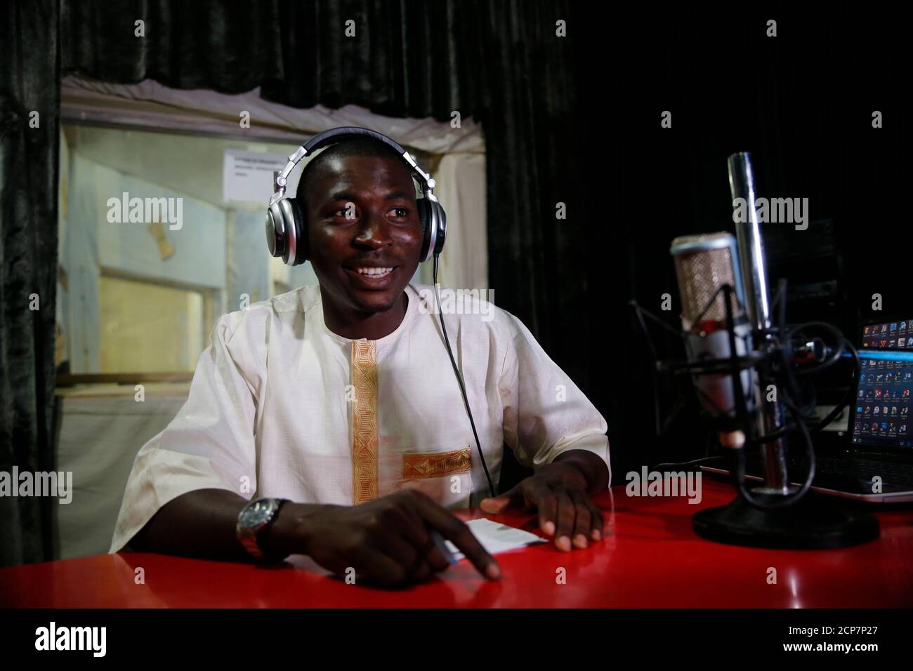 Presenter Nura Umar speaks into a microphone during a shortwave broadcast  for Dandal Kura at a radio station in Nigeria's northern region of Kano,  January 18, 2016. Dandal Kura, Kanuri for "meeting