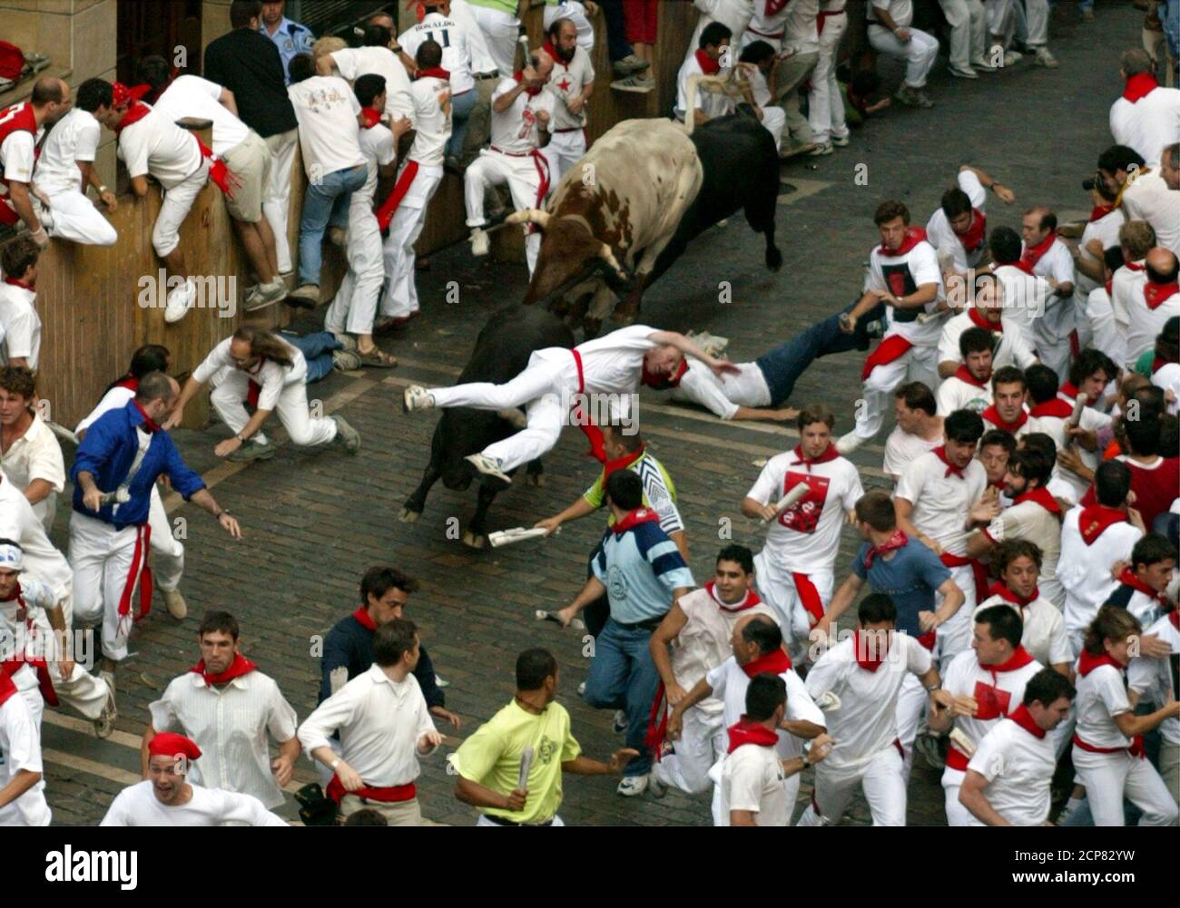 British bull runner David Bigging is lifted up by a bull while being gored during the sixth running of the bulls of the San Fermin festival in Pamplona on July 12, 2003. A pack of six fighting bulls and steers runs through the centre of the town to the bullring every morning during the week long festival made famous by US writer Ernest Hemingway. Bigging was treated for injuries and taken by ambulance to hospital. REUTERS/Paul Hanna  PH/JV Stock Photo