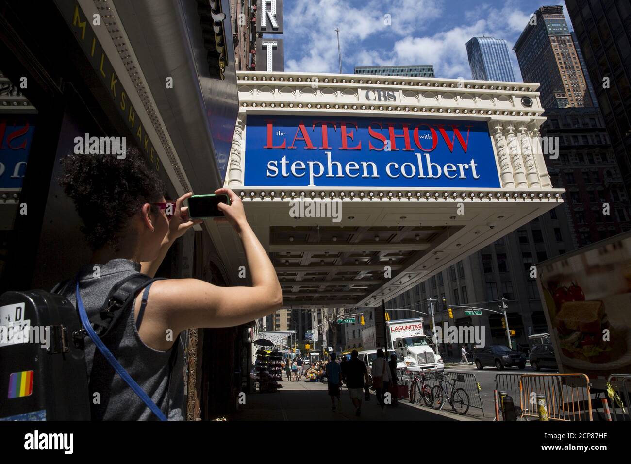 A girl takes a photo of the marquee for 'The Late Show with Stephen Colbert' at the Ed Sullivan Theater in Manhattan, New York, August 21, 2015. Colbert is set to host the show, which was previously presented by David Letterman. REUTERS/Andrew Kelly Stock Photo