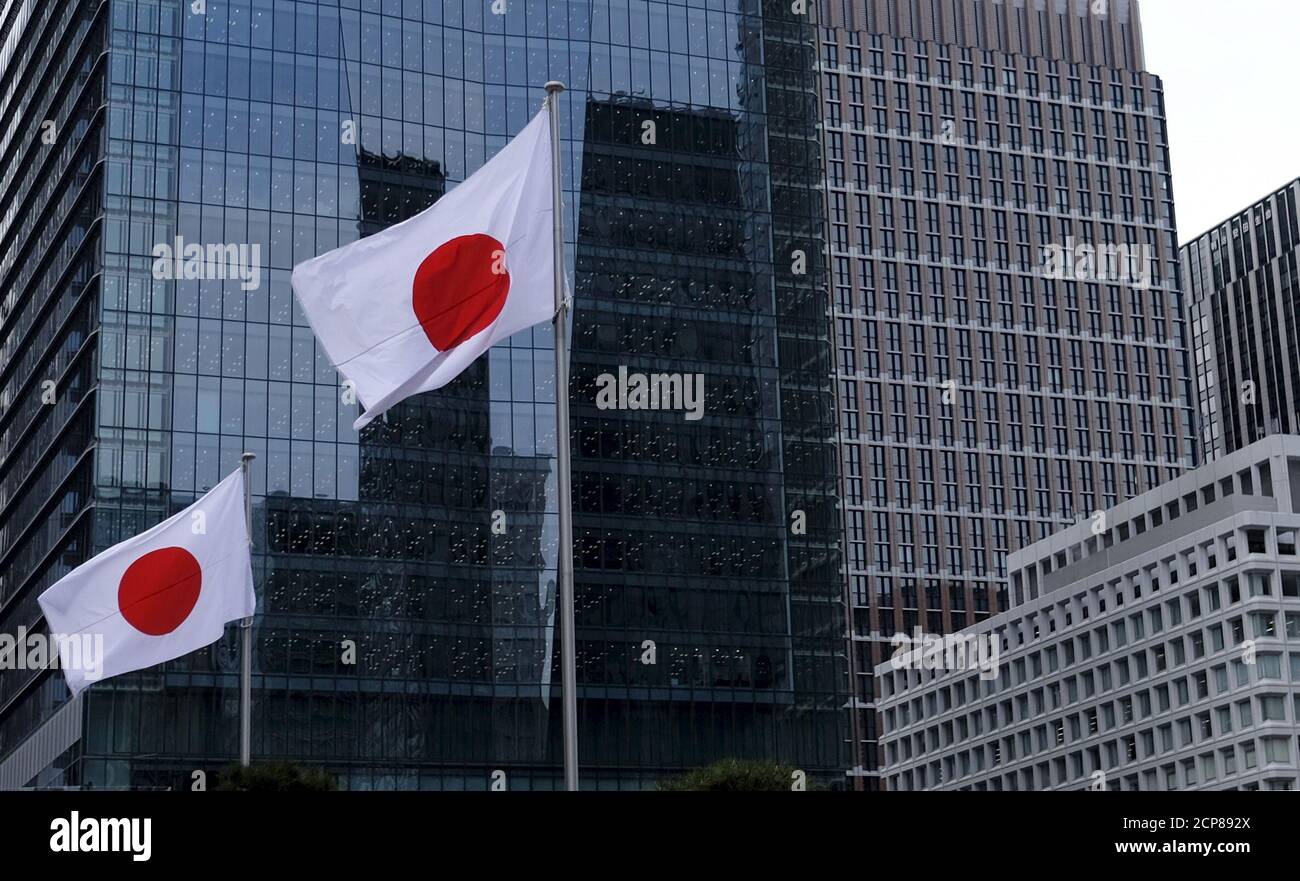 Japanese national flags flutter in front of buildings at Tokyo's business district in Japan, February 22, 2016. Growth in Japan's manufacturing activity slowed sharply in February as new export orders contracted at the fastest pace in three years, a worrying sign that overseas demand is deteriorating rapidly as China's economy slows, a preliminary survey showed on Monday. REUTERS/Toru Hanai TPX IMAGES OF THE DAY Stock Photo