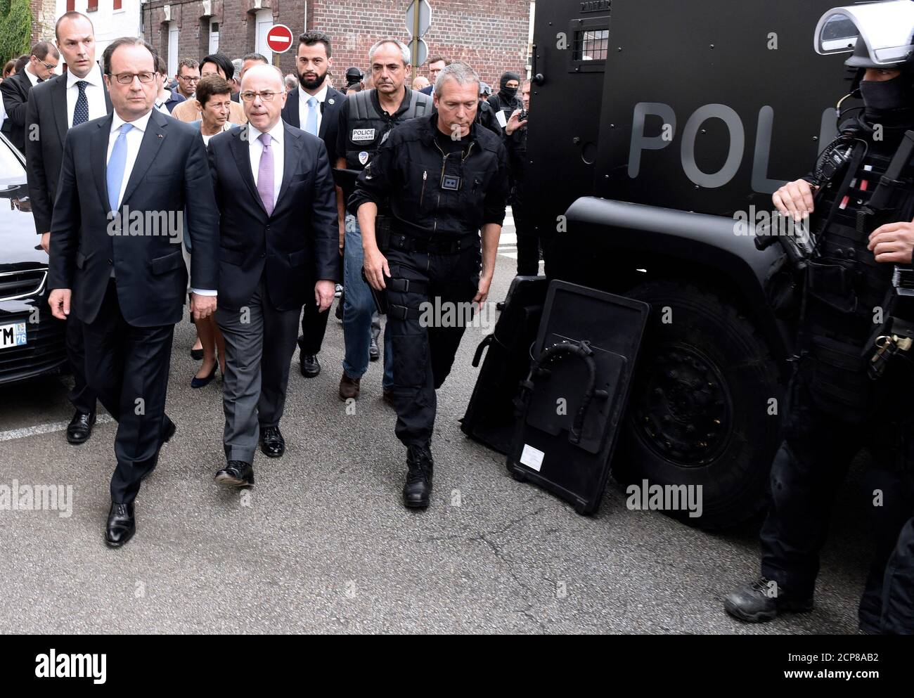 French President Francois Hollande (L), Interior Minister Bernard Cazeneuve (2ndL) and the Head of the French national police intervention group (RAID) Jean-Michel Fauvergue (R), arrive after a hostage-taking at a church in Saint-Etienne-du-Rouvray, France, July 26, 2016. A priest was killed with a knife and another hostage seriously wounded in an attack on a church that was carried out by assailants linked to Islamic State.    REUTERS/Boris Maslard/Pool Stock Photo