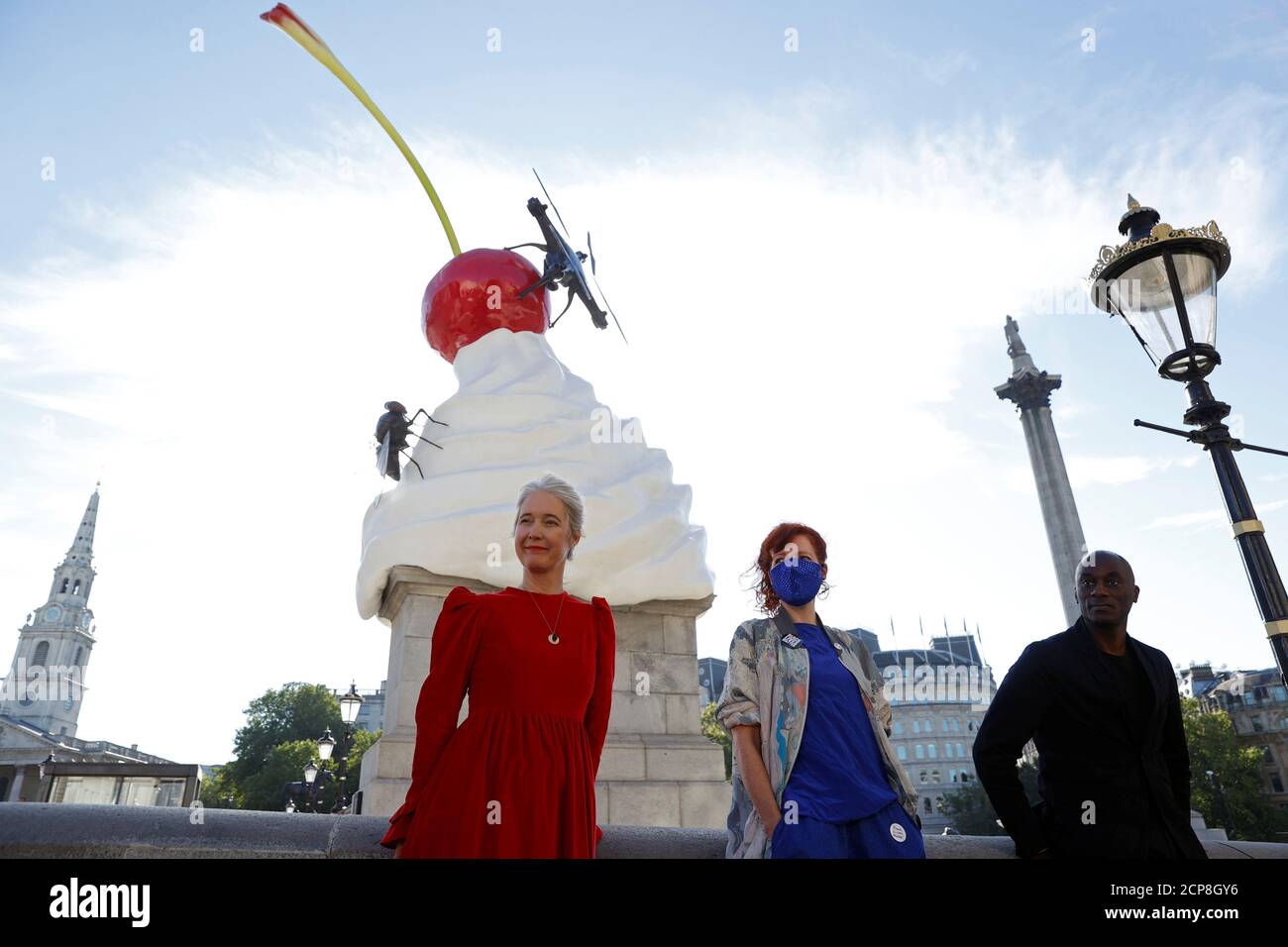 Deputy Mayor for Culture and Creative Industries Justine Simons OBE, Artist Heather Phillipson and Chair of the Fourth Plinth Comissioning Group Ekow Eshun pose next to Phillipson's sculpture ''THE END'', after it was unveiled on Trafalgar Square's Fourth Plinth, in London, Britain, July 30, 2020. REUTERS/John Sibley Stock Photo
