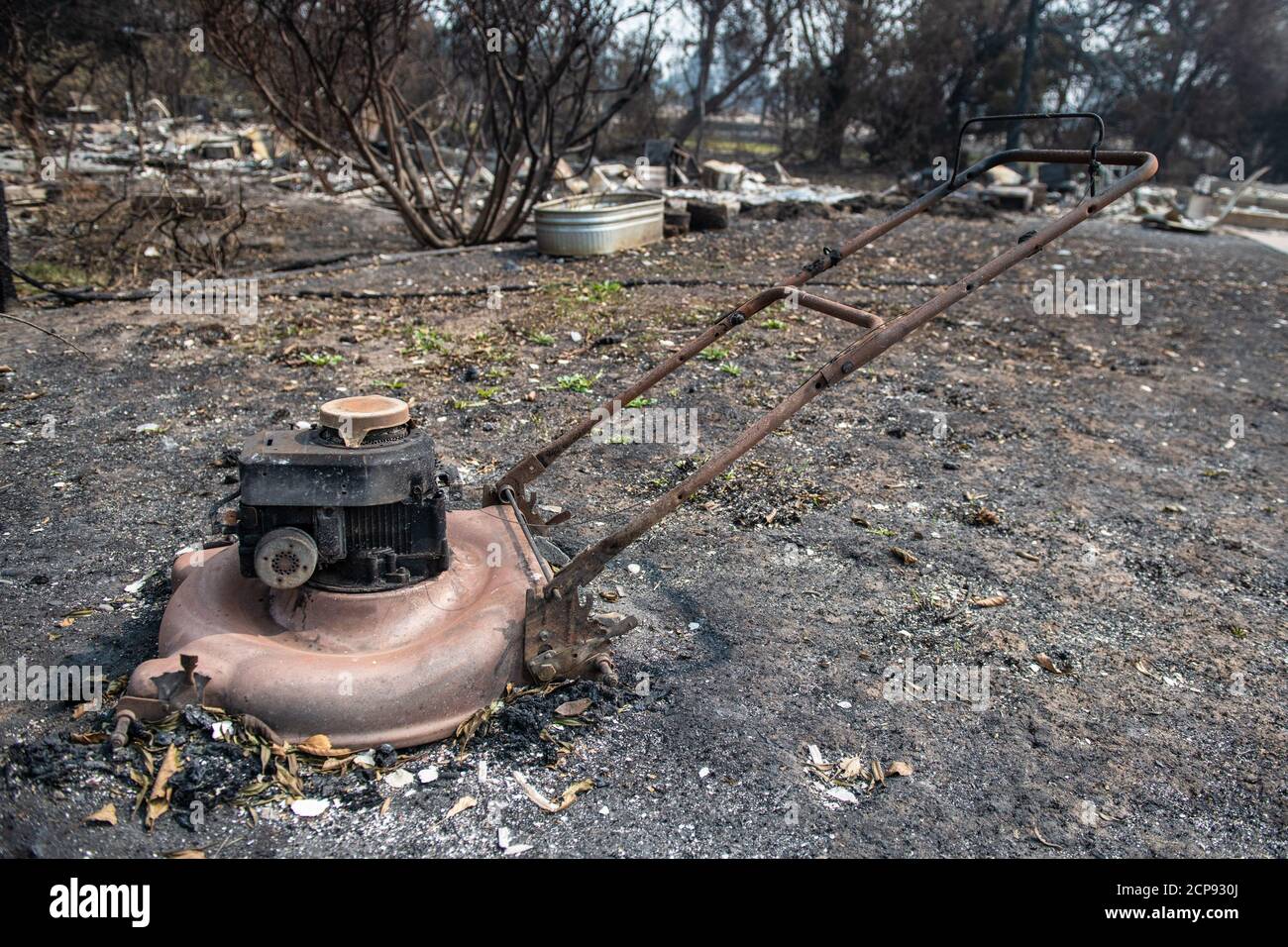 TALENT, ORE - SEPTEMBER 18, 2020: A general view of a burned out lawnmower amid the aftermath of the Almeda Fire. The town of Talent, Oregon, showing the burned out homes, cars and rubble left behind. In Talent, about 20 miles north of the California border, homes were charred beyond recognition. Across the western US, at least 87 wildfires are burning, according to the National Interagency Fire Center. They've torched more than 4.7 million acres -- more than six times the area of Rhode Island. Credit: Chris Tuite/imageSPACE Stock Photo