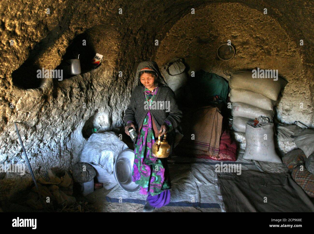 An Afghan Woman Prepares Tea At Lunch Time At An Ancient Cave In Bamiyan In The Central Province Of Afghanistan About 260 Km 161 Miles Northwest Of Kabul March 29 05 Poor An Afghan Woman Prepares Tea At Lunch Time At An Ancient Cave In Bamiyan In The Central Province Of Afghanistan About 260 Km 161 Miles Northwest Of Kabul March 29 05 Poor