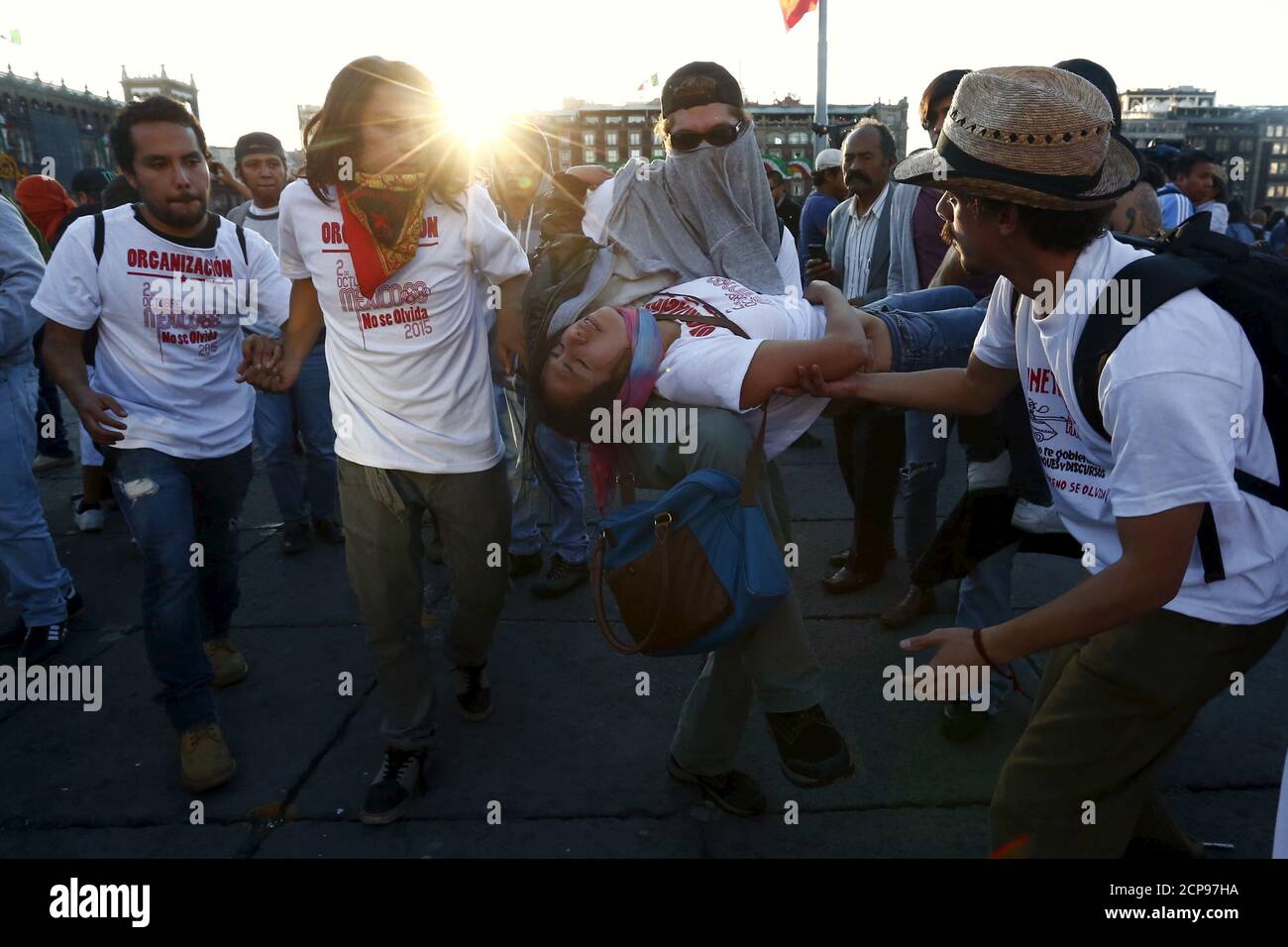 A protester, who fainted, is carried during clashes with riot police at a march marking the 47th anniversary of the 1968 Tlatelolco square massacre at Zocalo square in Mexico City, October 2, 2015. Thousands took part in the march to mark the 47th anniversary of the student massacre at which dozens, maybe hundreds, of protesters were gunned down by the army in a brutal repression of the student movement. REUTERS/Edgard Garrido Stock Photo
