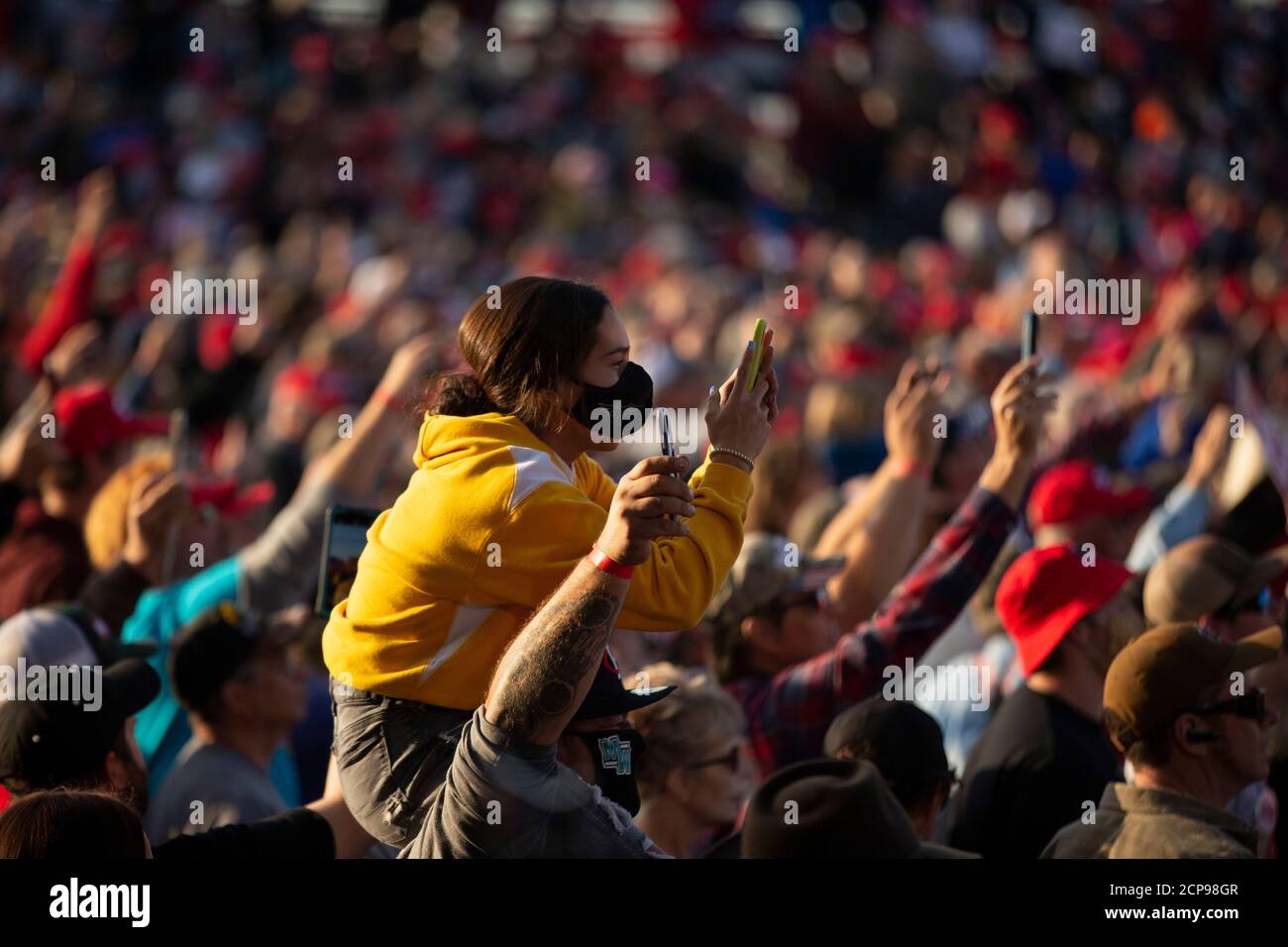 Bemidji, Minnesota, USA. 18th Sep, 2020. September 18, 2020: A girl on the shoulders of her father uses her phone to document Air Force One landing at Bemidji Regional Airport on Sep 18, 2020. Credit: Chris Juhn/ZUMA Wire/Alamy Live News Credit: ZUMA Press, Inc./Alamy Live News Stock Photo
