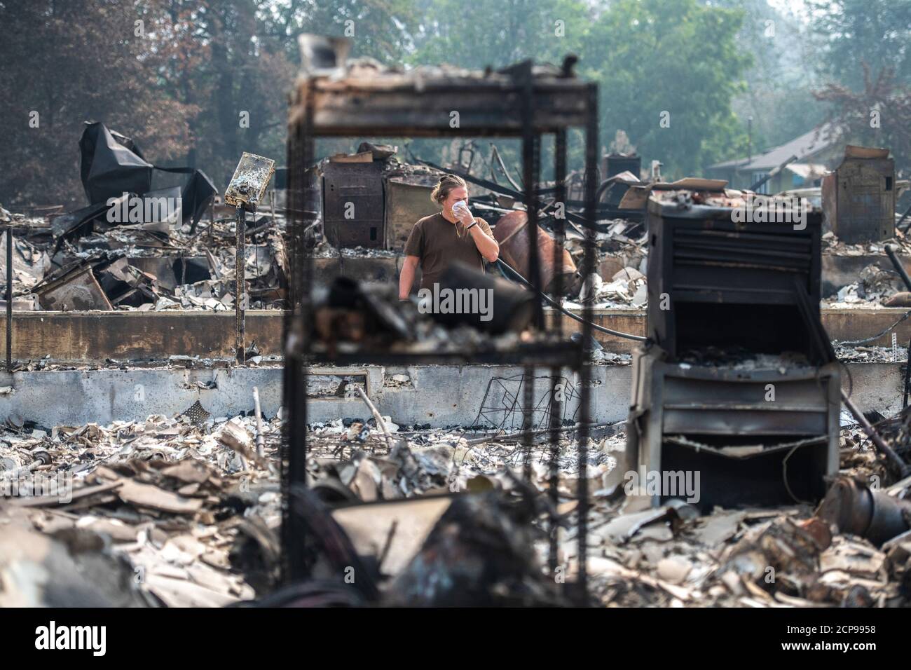 Talent, Ore. 18th Sep, 2020. Zach Kuhlow checks the remnants of his house for anything salvagable. His son, who is now 10, was born inside the house. In Talent, about 20 miles north of the California border, homes were charred beyond recognition. Across the western US, at least 87 wildfires are burning, according to the National Interagency Fire Center. They've torched more than 4.7 million acres -- more than six times the area of Rhode Island. Credit: Chris Tuite/Image Space/Media Punch/Alamy Live News Stock Photo