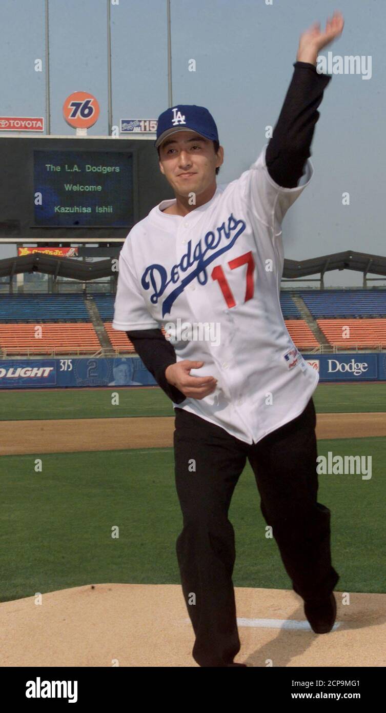 Japanese all-star left handed pitcher Kazuhisa Ishii wears his Los Angeles  Dodgers jersey and cap as he pretends to throw a pitch on the mound at  Dodger stadium after a news conference,