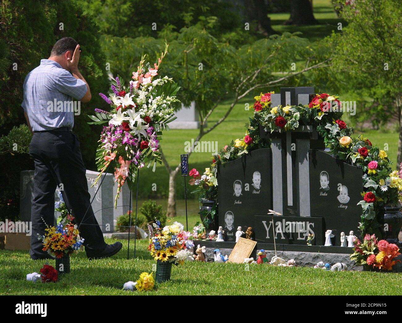 Russell Yates, husband of Andrea Pia Yates, visits the grave of his five  children in Houston, June 20, 2002, on the one year anniversary of their  deaths. Andrea Yates was convicted of