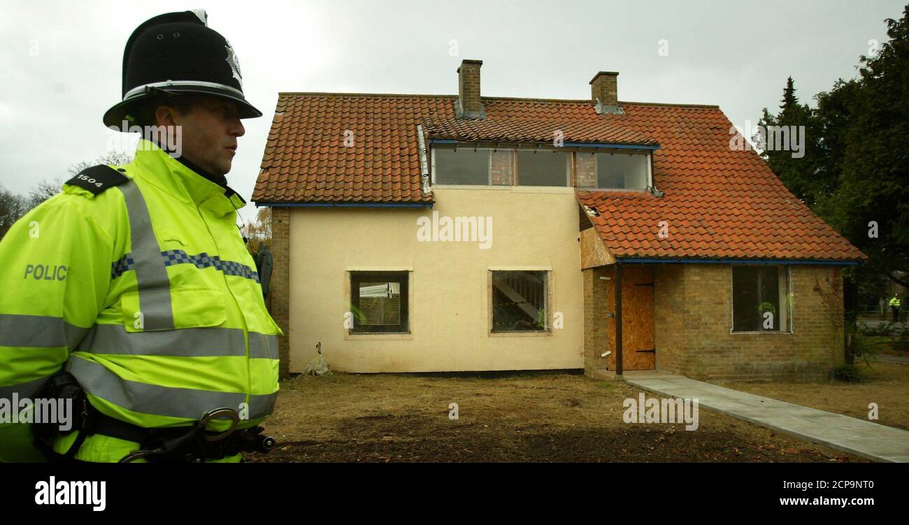 Police stand guard outside the home of Britain's Ian Huntley in the grounds of Soham Village College, Cambridgeshire, November 10, 2003. Huntley was jailed for the murder of 10-year-olds Holly Wells and Jessica Chapman in the summer of 2002. REUTERS/Peter Macdiarmid  PKM/ASA/CRB Stock Photo
