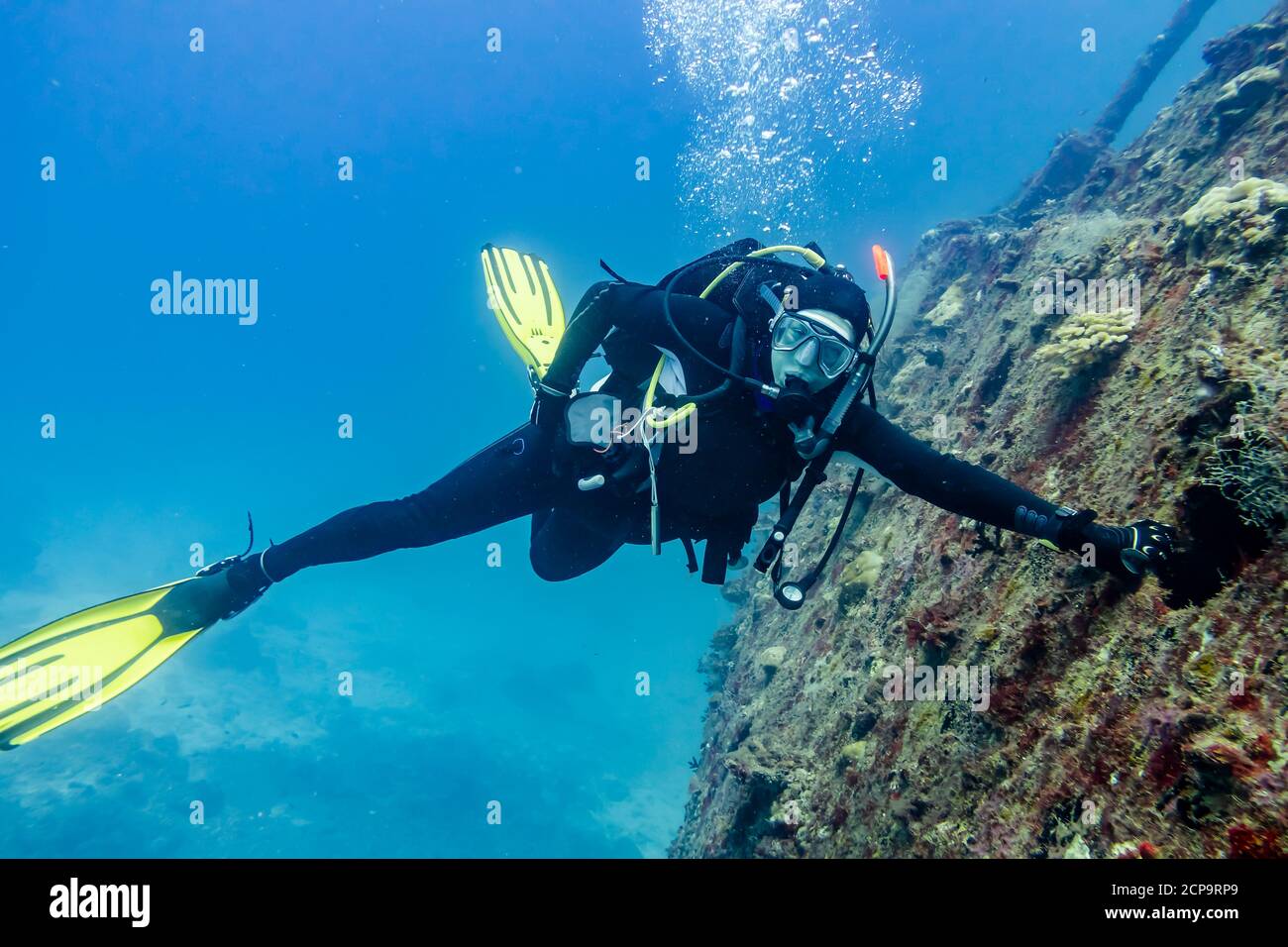 Diver near the sunken ship at the bottom of the Indian ocean Stock Photo