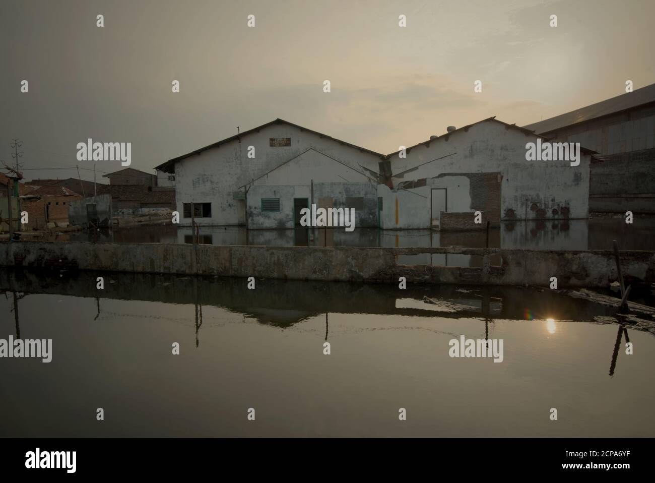 Submerged warehouse buildings on a coastal area suffering from land