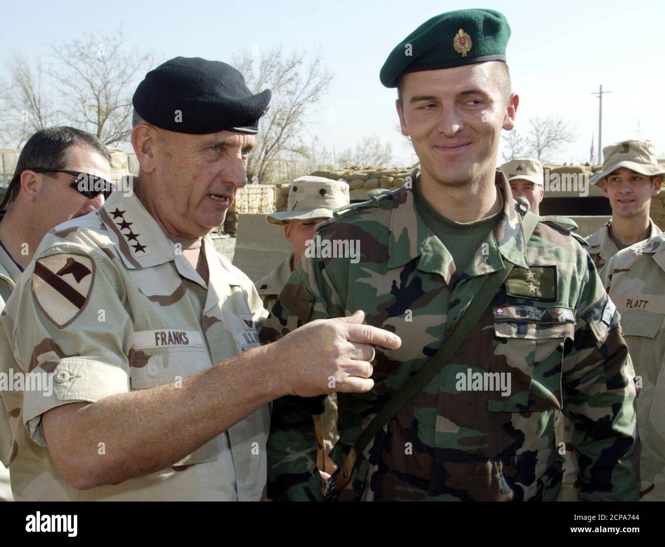 U.S. Army General Tommy Franks (L), chief of the U.S. and the coalition forces, talks with a Slovak peacekeeper from the Coalition Joint Task Force 180 at Bagram air base November 29, 2002. Around 12,000 U.S. troops are participating at the operation 'Enduring Freedom' in Afghanistan. REUTERS/Radu Sigheti  RS/CP Stock Photo
