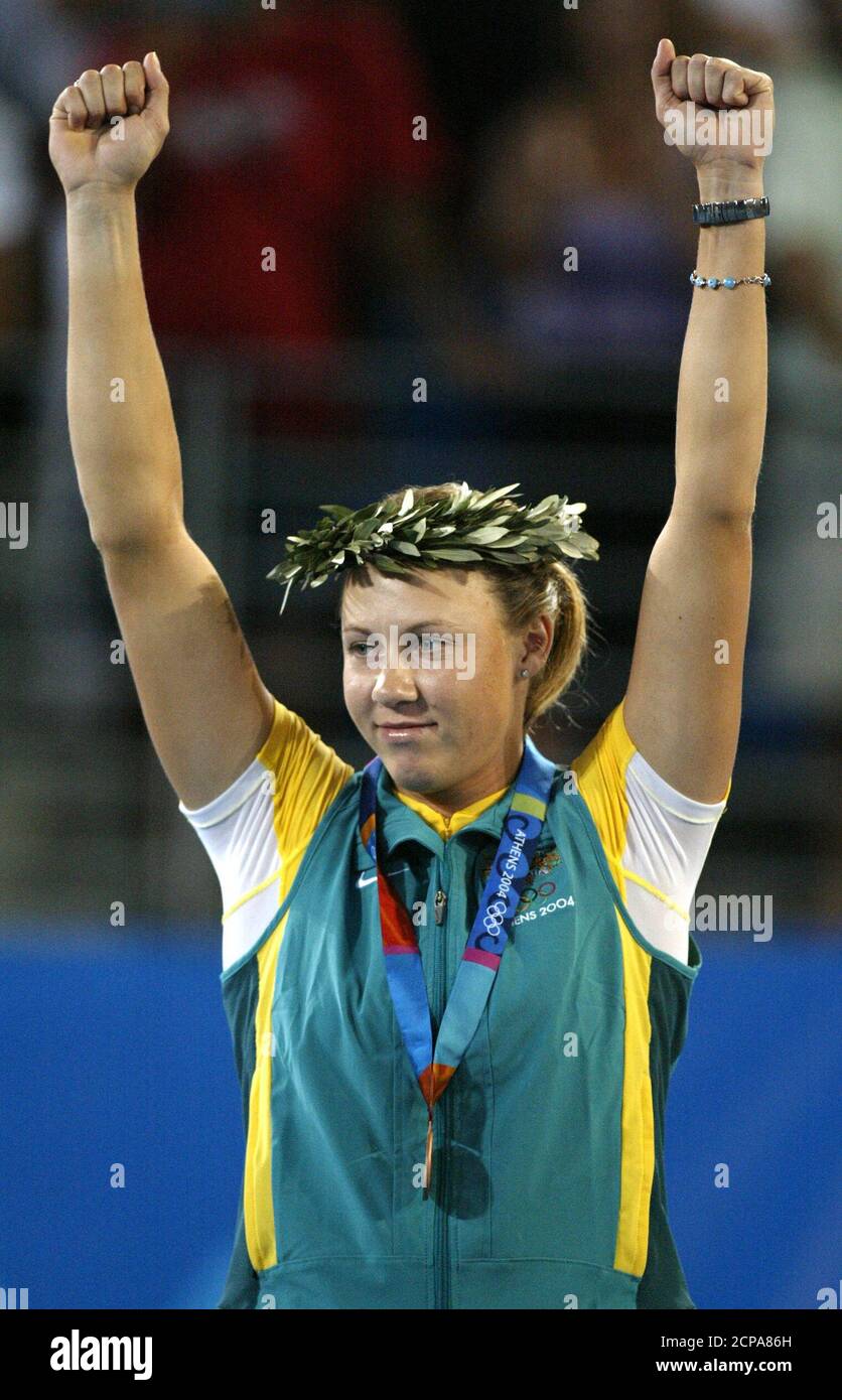Bronze medalist Molik waves from the podium after the ceremony for the women's single tennis event of Athens 2004 Olympic Games.  Australia's Alicia Molik waves from the podium after receiving her bronze medal in the women's singles tennis competition at the Athens 2004 Olympic Games, August 21, 2004. Belgium's Justine Henin-Hardenne won the gold and France's Amelie Mauresmo won silver. REUTERS/Carlos Barria Stock Photo