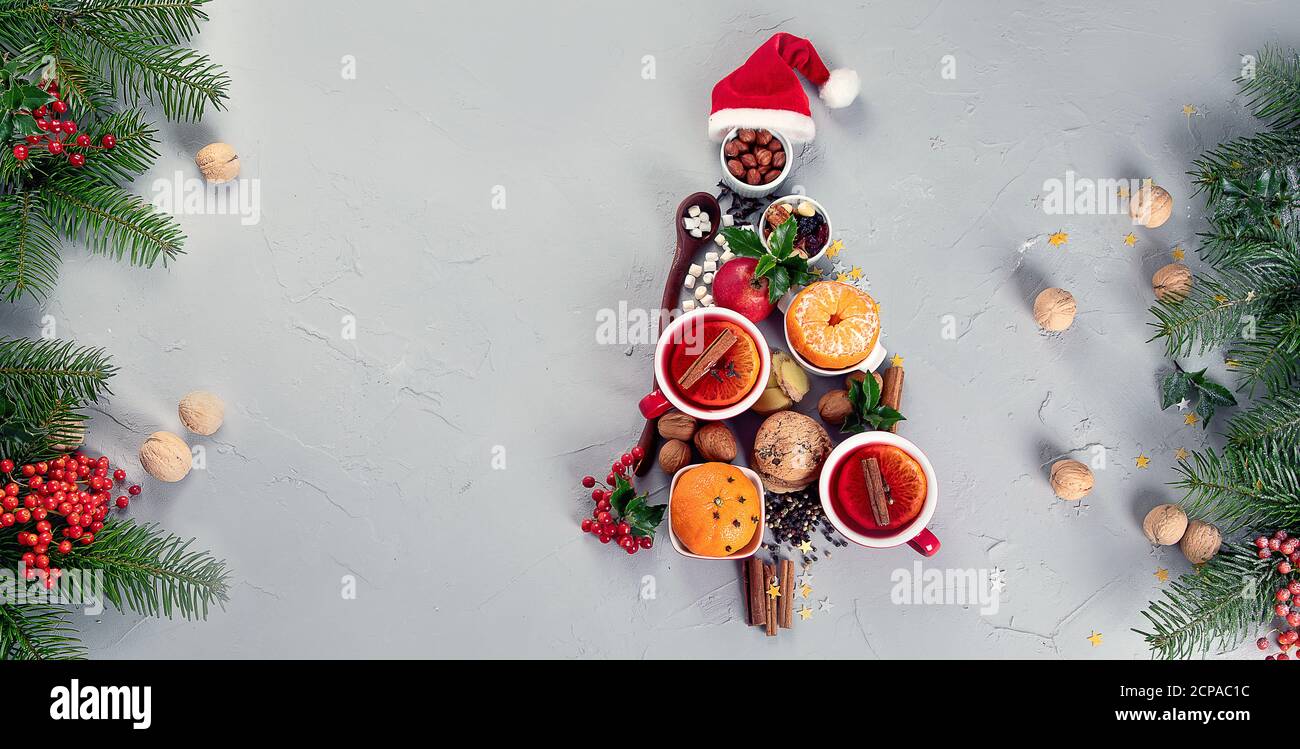 Christmas Tree made of holiday food on concrete background. Top view, flat lay. Christmas concept. New Year Holidays background. Stock Photo