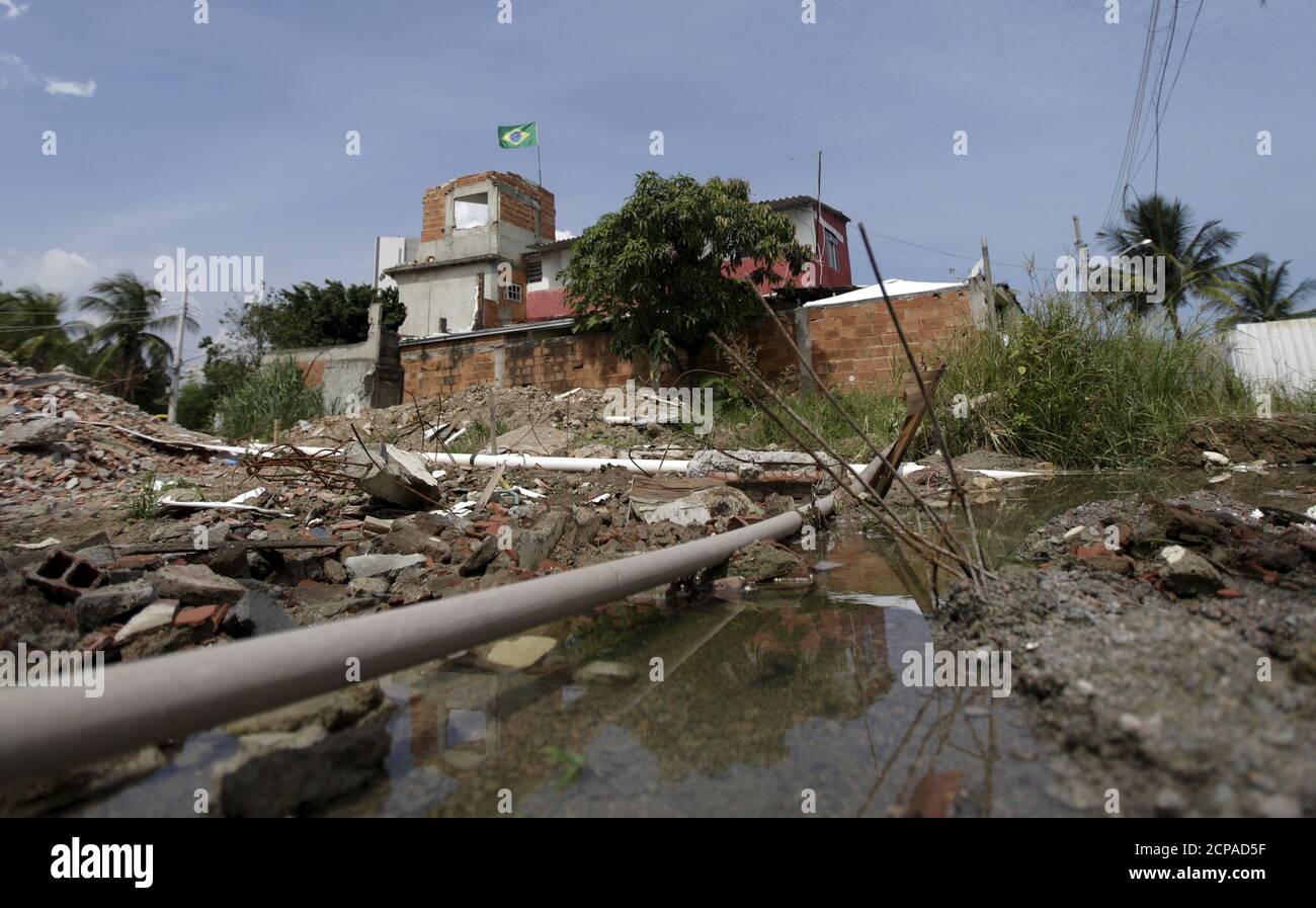 Water is pictured amid debris and houses of Vila Autodromo community in Rio de Janeiro, Brazil, February 23, 2016. The few families that remain in the Vila Autodromo favela after removals swept the community to make way for the Olympic Park, are now struggling with several cases of Zika and dengue fever, as mosquitoes breed in water holes left untreated around the construction site.       To match HEALTH-ZIKA/BRAZIL-OLYMPICS        REUTERS/Ricardo Moraes Stock Photo