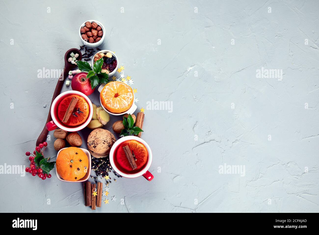 Christmas Tree made of holiday food on concrete background. Top view, flat lay with copy space. Christmas concept. New Year Holidays background. Stock Photo
