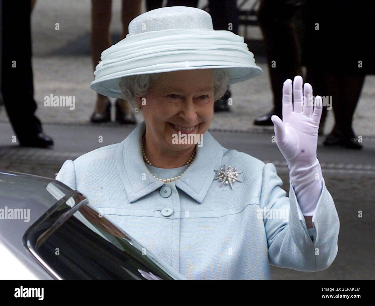 British Queen Elizabeth waves to well wishers as she leaves the new British embassy after an opening ceremony in Berlin July 18. The new embassy designed by British architect Michael Wilford is based on the same site as the old building which was destroyed by Allied bombers in World War Two.  MUR Stock Photo