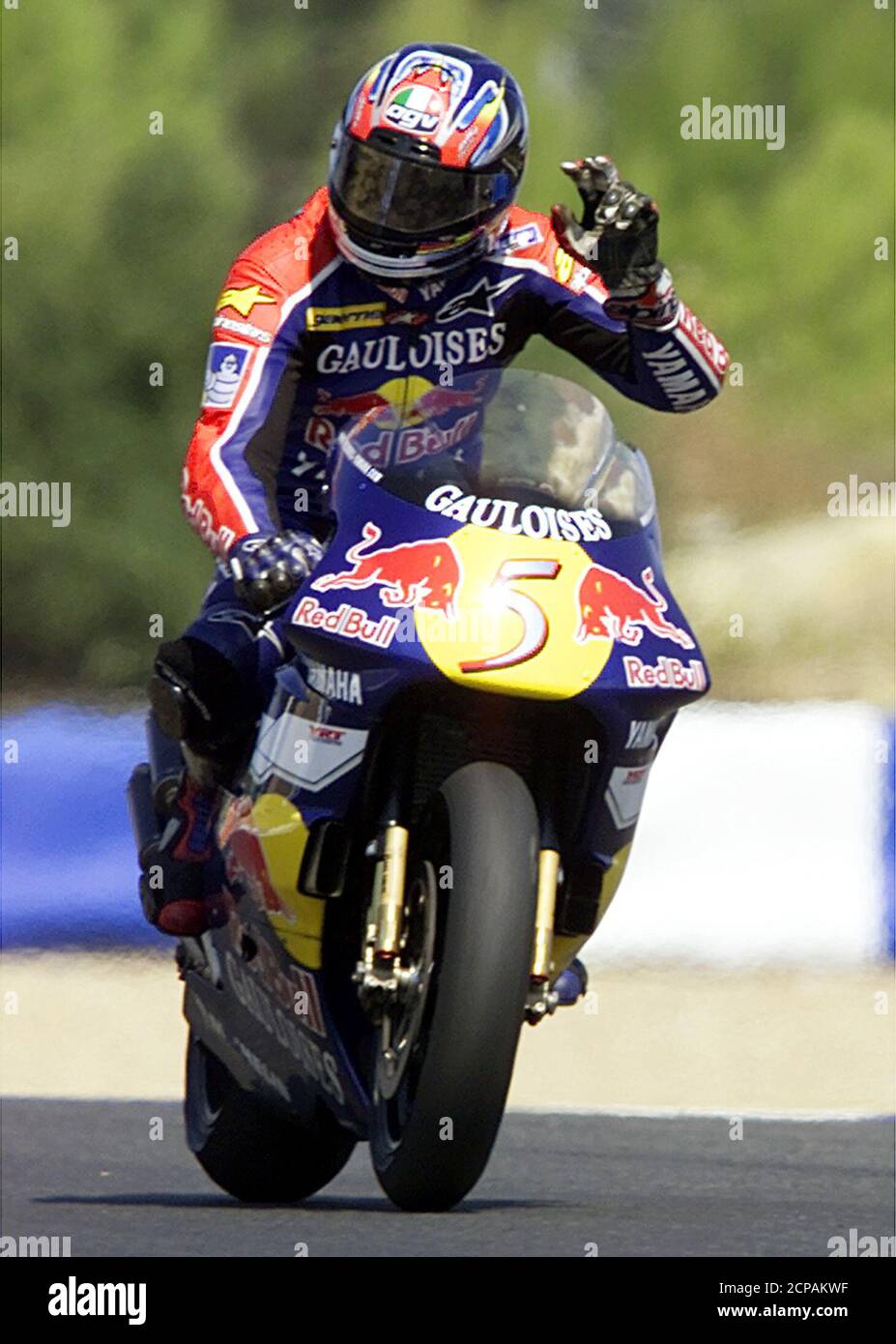 Italian 500cc motorcyclist Valentino Rossi gestures crossing the finish  line and winning the Portuguese Grand Prix September 9, 2001. Valentino  Rossi, riding a Honda, won the race in 47 minutes 25.357 seconds.