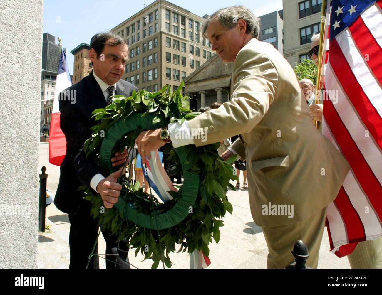 French Consul General in Boston Thierry Vankerk-Hoven (L) and Massachusetts Lafayette Society President William Dunham (R) lay a wreath at a memorial commemorating the Marquis de Lafayette, a French General and politician who became a hero in the American revolutionary war, at ceremonies in Boston, May 20, 2003. French and local officials joined together on the 169th anniversary of his death to reassert the common democratic values of the two countries despite recent diplomatic and military policy differences. REUTERS/Jim Bourg  JRB Stock Photo