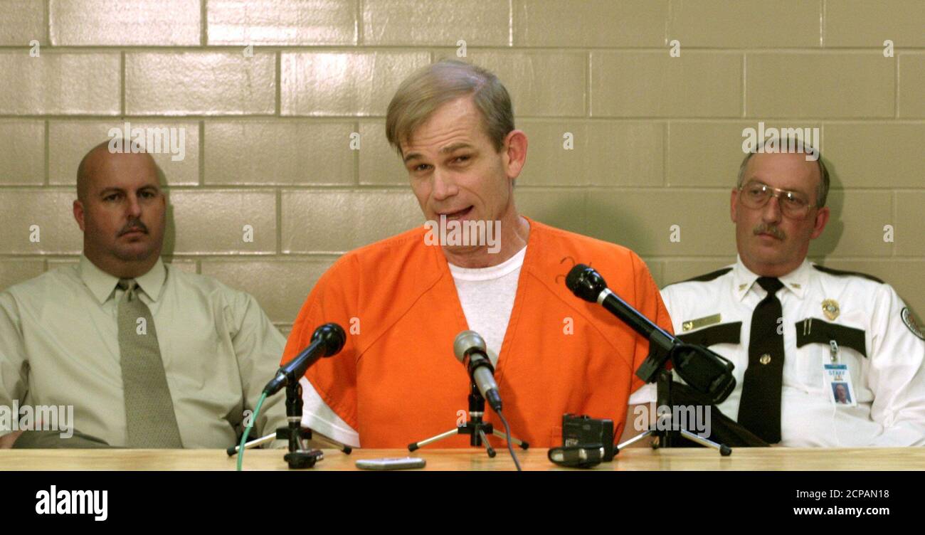 Warden Allen Clark (L) of the New River Correctional facility and Coronal Lamar Griffis (R) of the Florida State Prisons listens as condemned murder Paul Hill gives his last press conference in Starke, Florida, September 2, 2003. The anti-abortion activist, who murdered a doctor and bodyguard at a Florida abortion clinic, said Tuesday on the eve of his execution that his death would make him a martyr and he expected others to follow in his footsteps. Barring a last-minute stay, Hill will be executed by chemical injection Wednesday, becoming the first killer of a doctor who provided abortions t Stock Photo