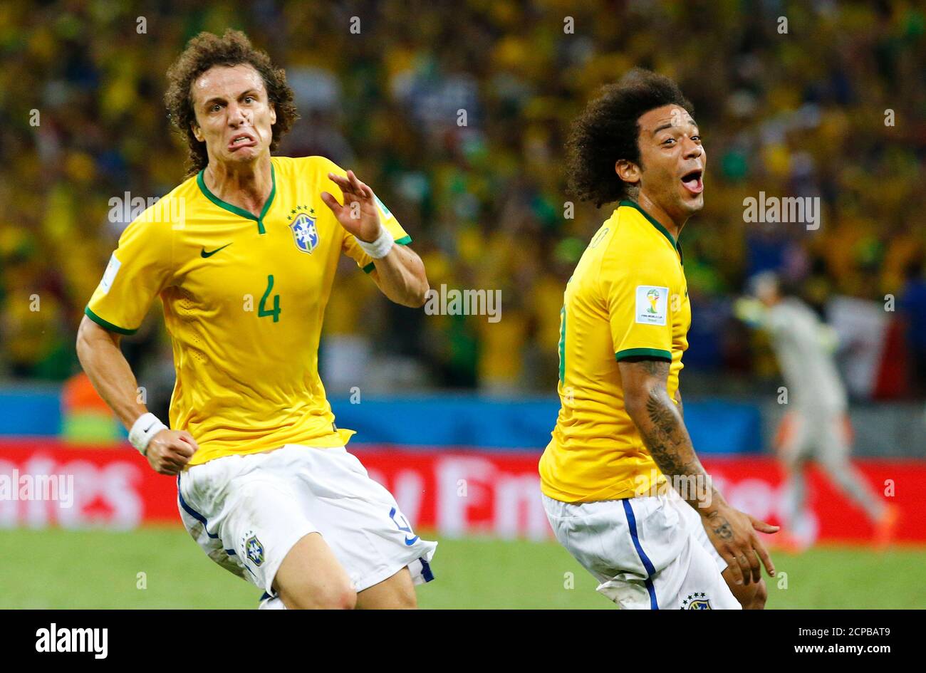 Brazil's David Luiz celebrates after scoring a goal against Colombia next to teammate Marcelo during their 2014 World Cup quarter-finals at the Castelao arena in Fortaleza July 4, 2014.  REUTERS/Stefano Rellandini (BRAZIL  - Tags: SOCCER SPORT WORLD CUP) Stock Photo