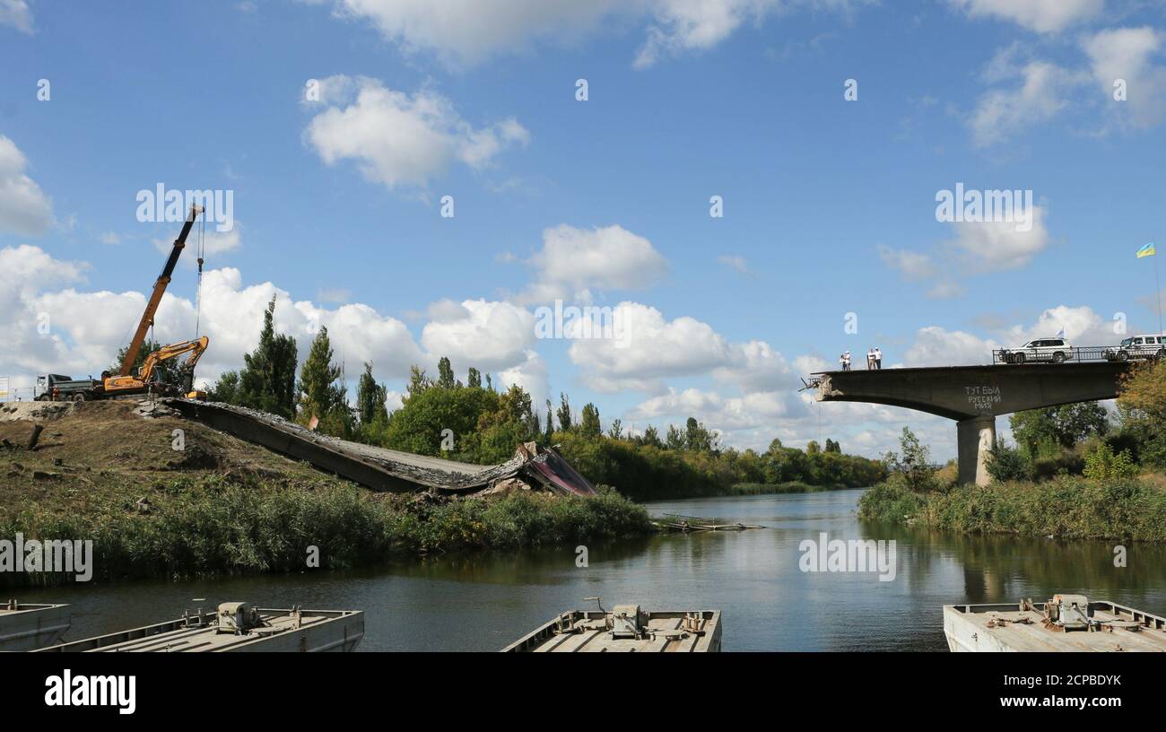 The OSCE team inspects the bridge that was bombed by separatists in early 2014 and is now being rebuilt in Sloviansk, Eastern Ukraine on September 15, 2016. REUTERS/Andrea Shalal Stock Photo